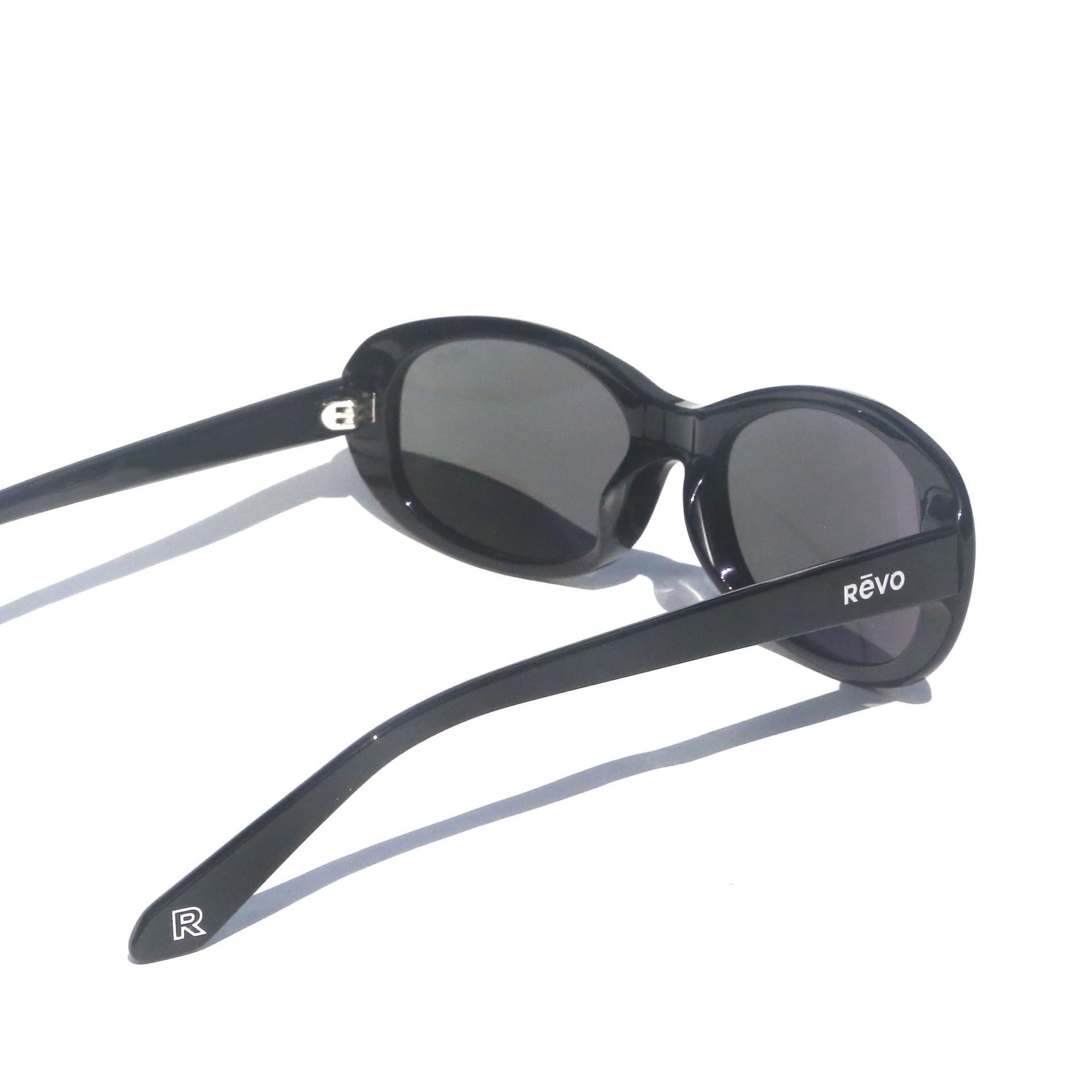 Black sunglasses with 'Revo' logo on a white background