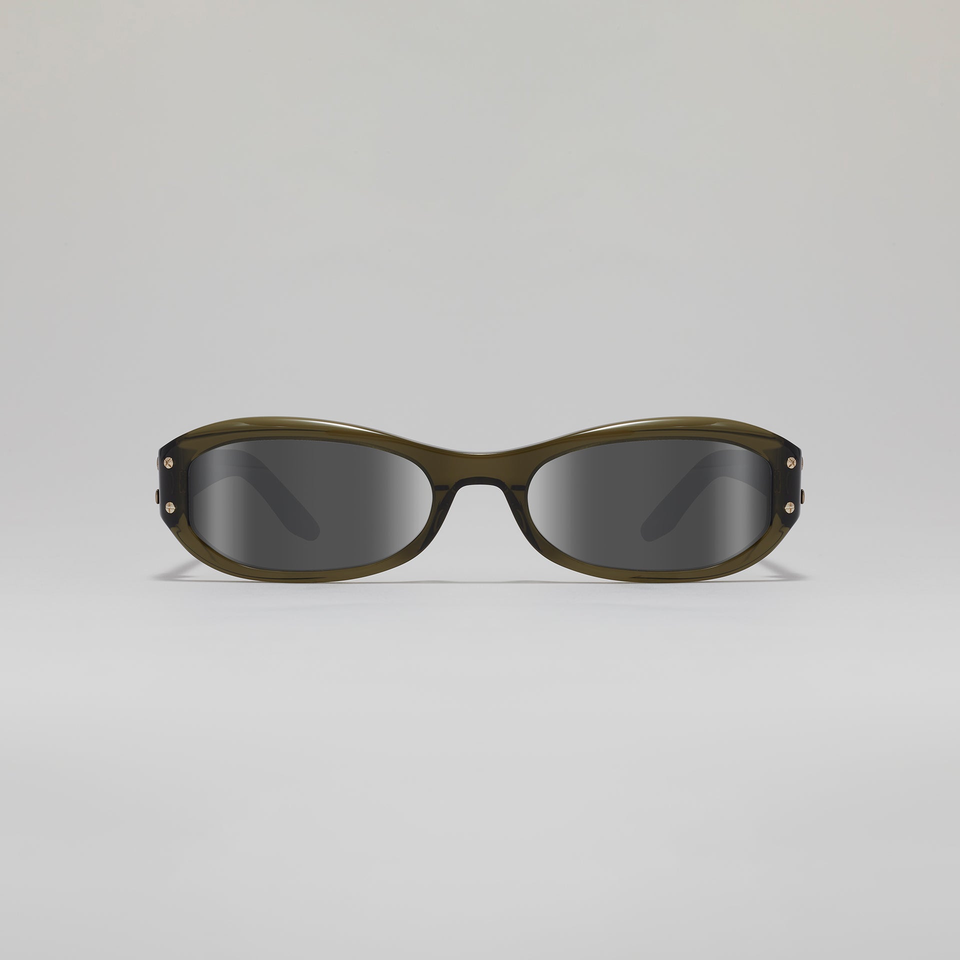 Sunglasses with a green frame and dark lenses on a light gray background