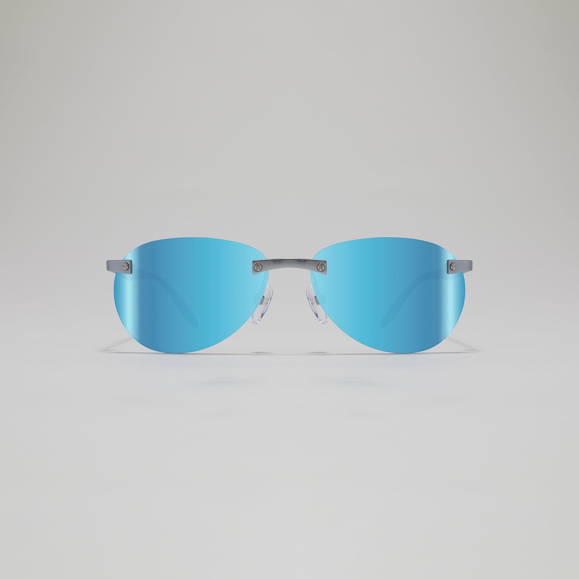 Sunglasses with blue lenses and gray frames on a light gray background