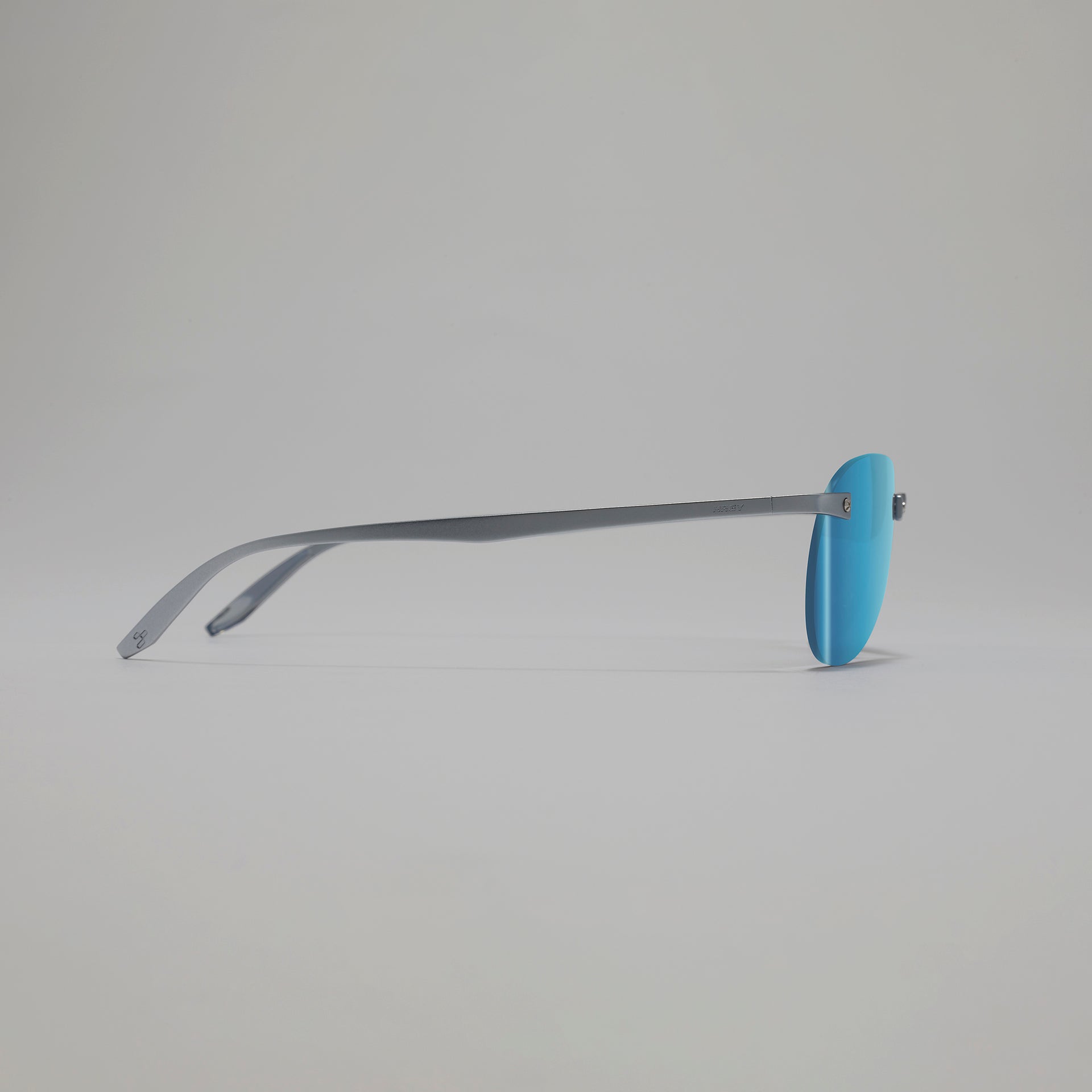 Sunglasses with blue lenses and gray frame on a light gray background