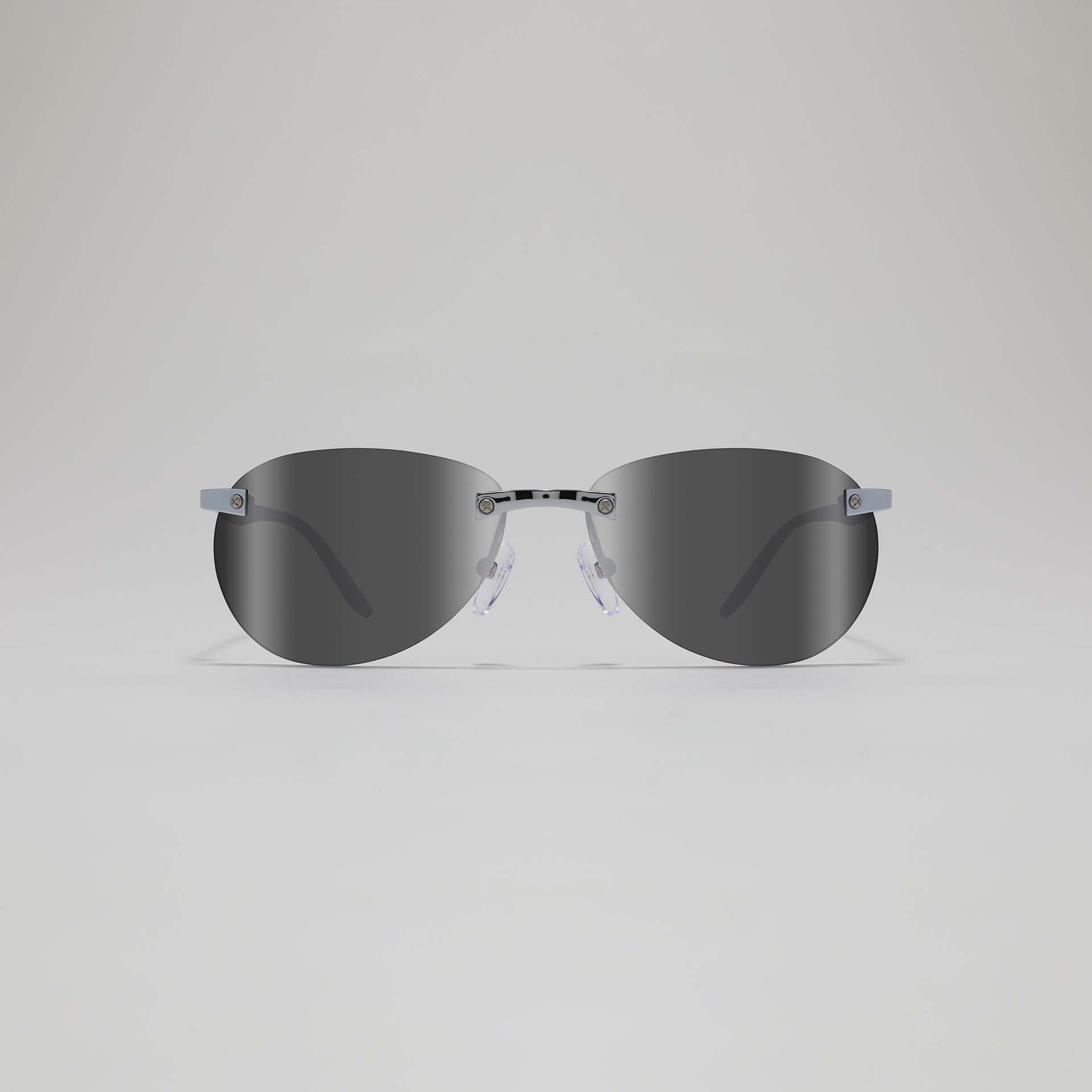 Sunglasses with dark lenses and thin frame on a light gray background