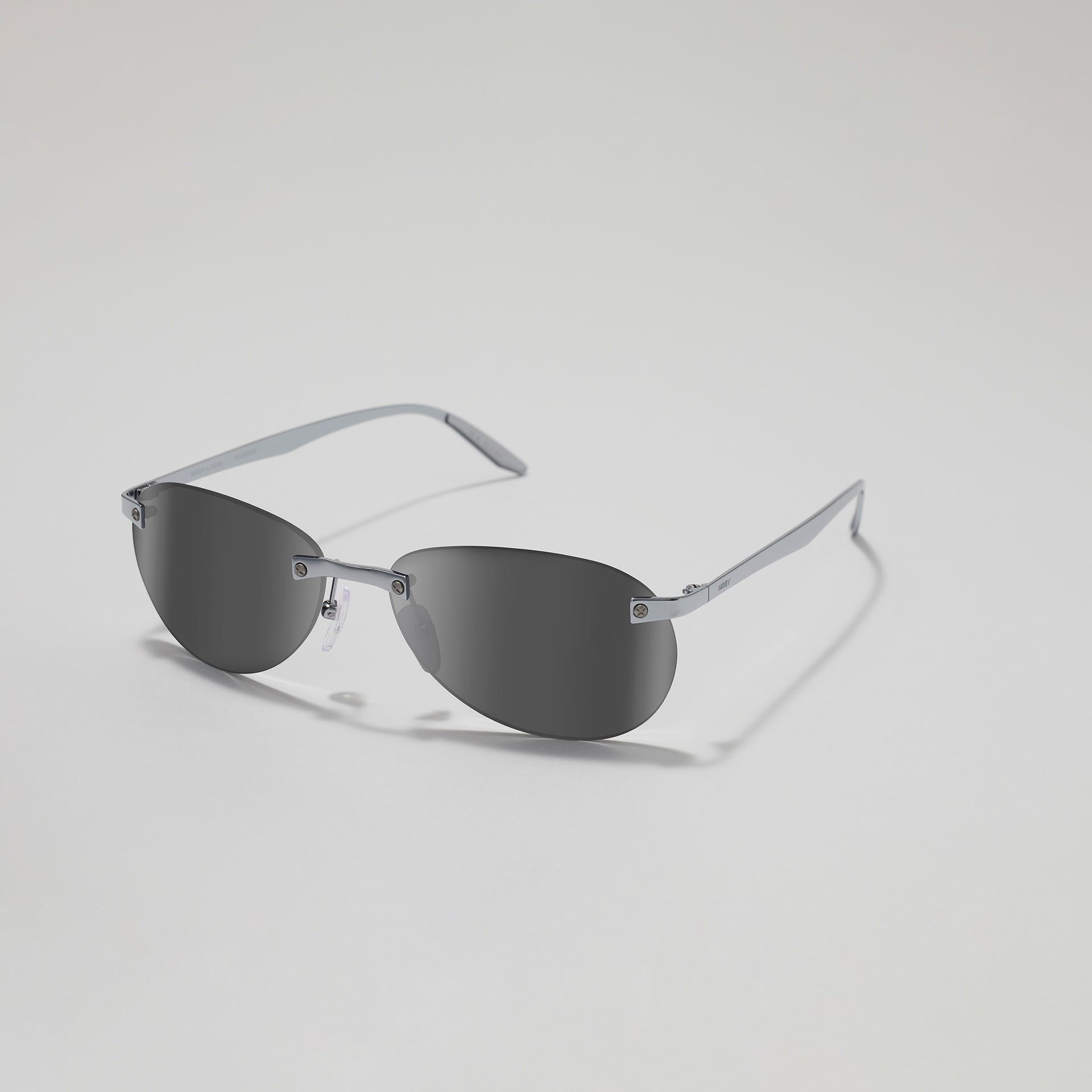 Sunglasses with a metallic frame on a light gray background