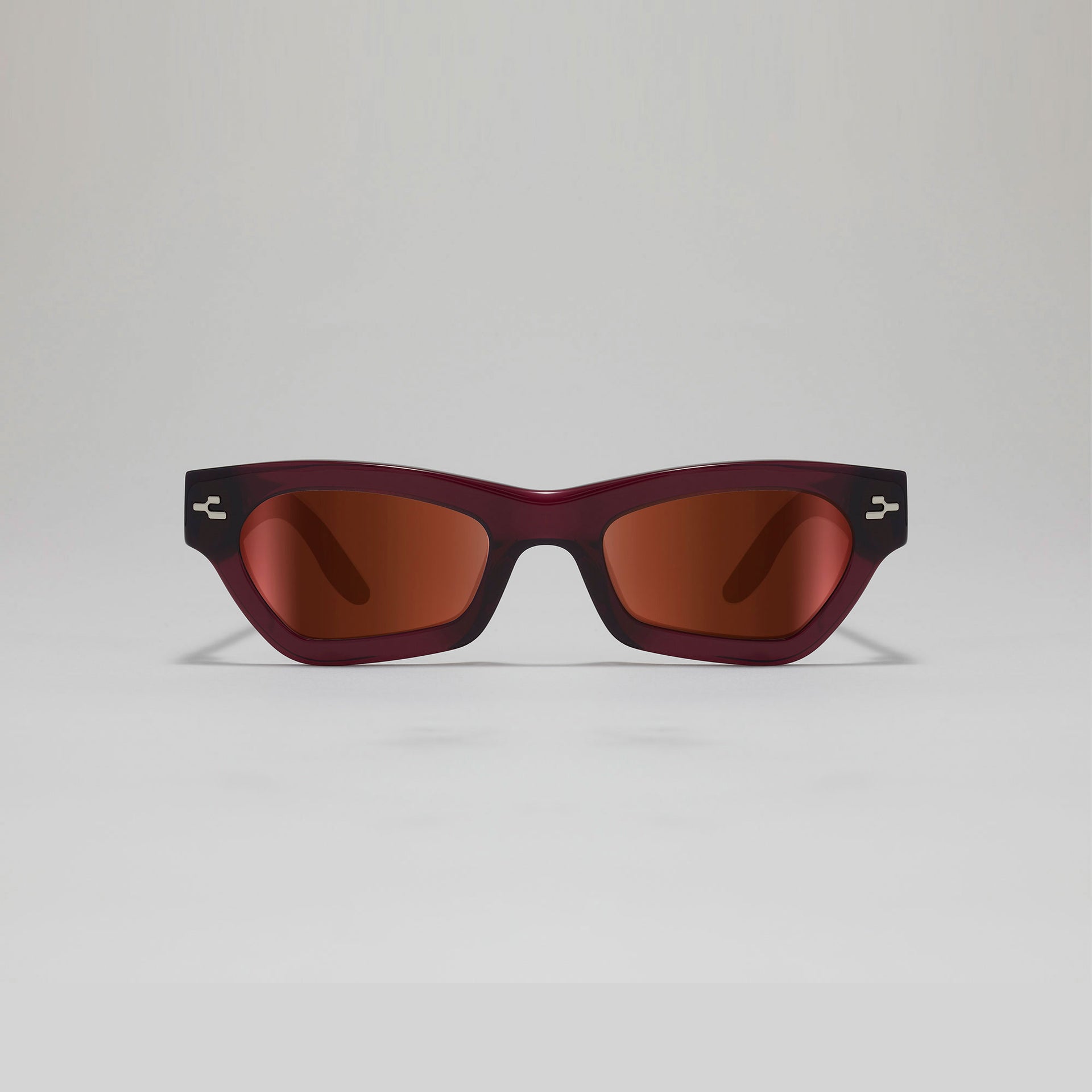 Sunglasses with a maroon frame and brown lenses on a light gray background