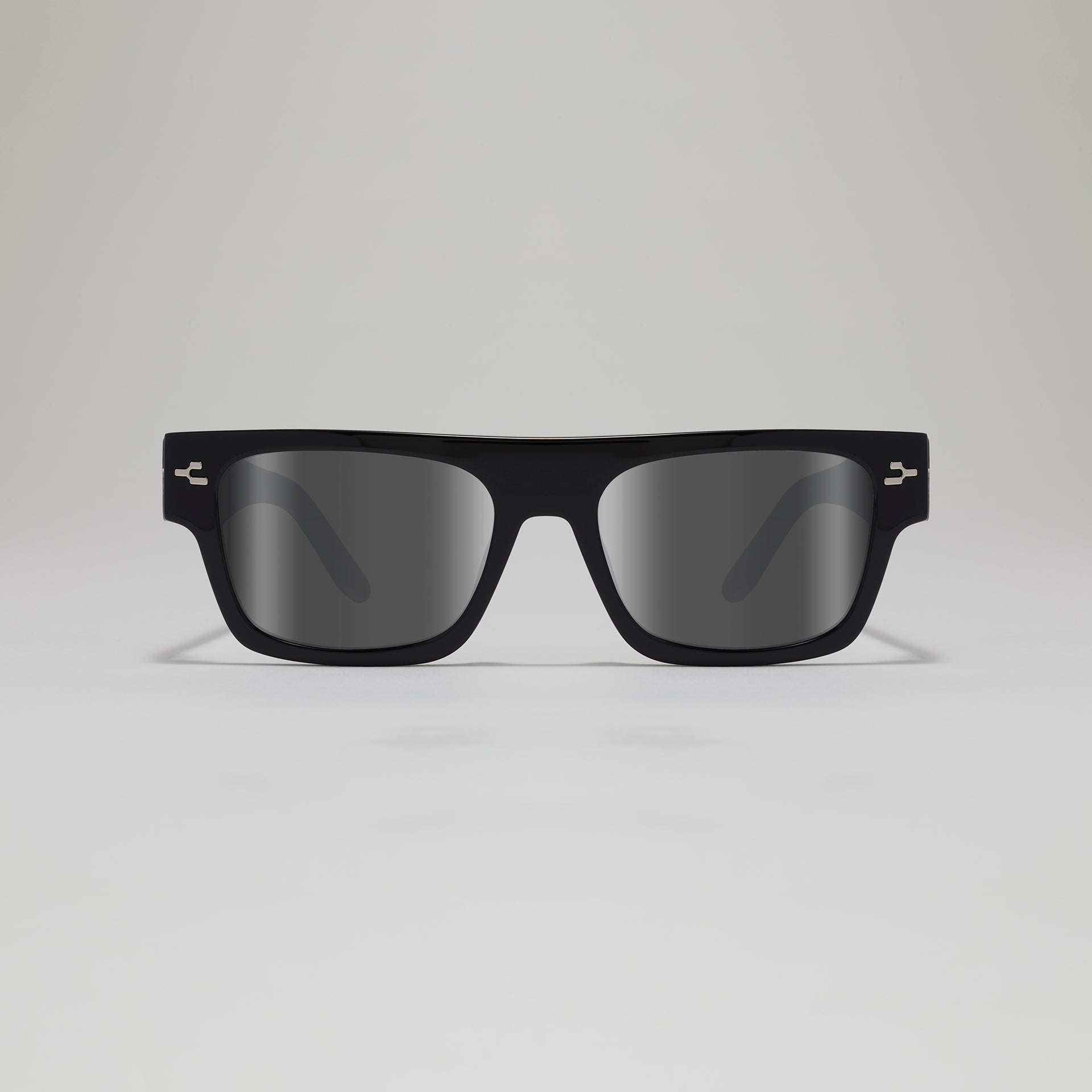 Black sunglasses with reflective lenses on a light gray background