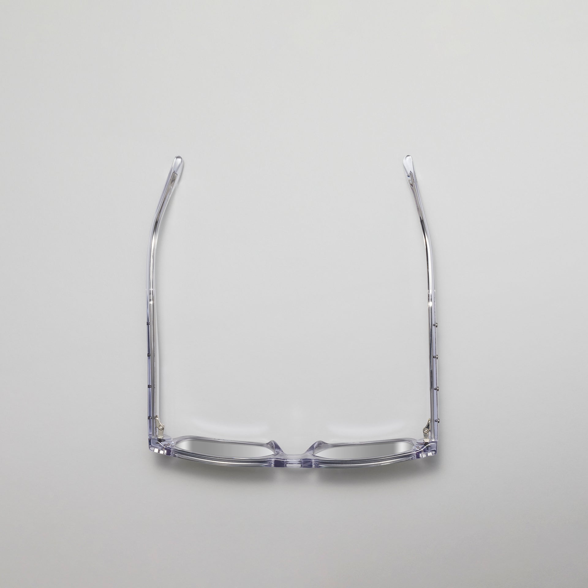 Clear eyeglasses frame on a light gray background