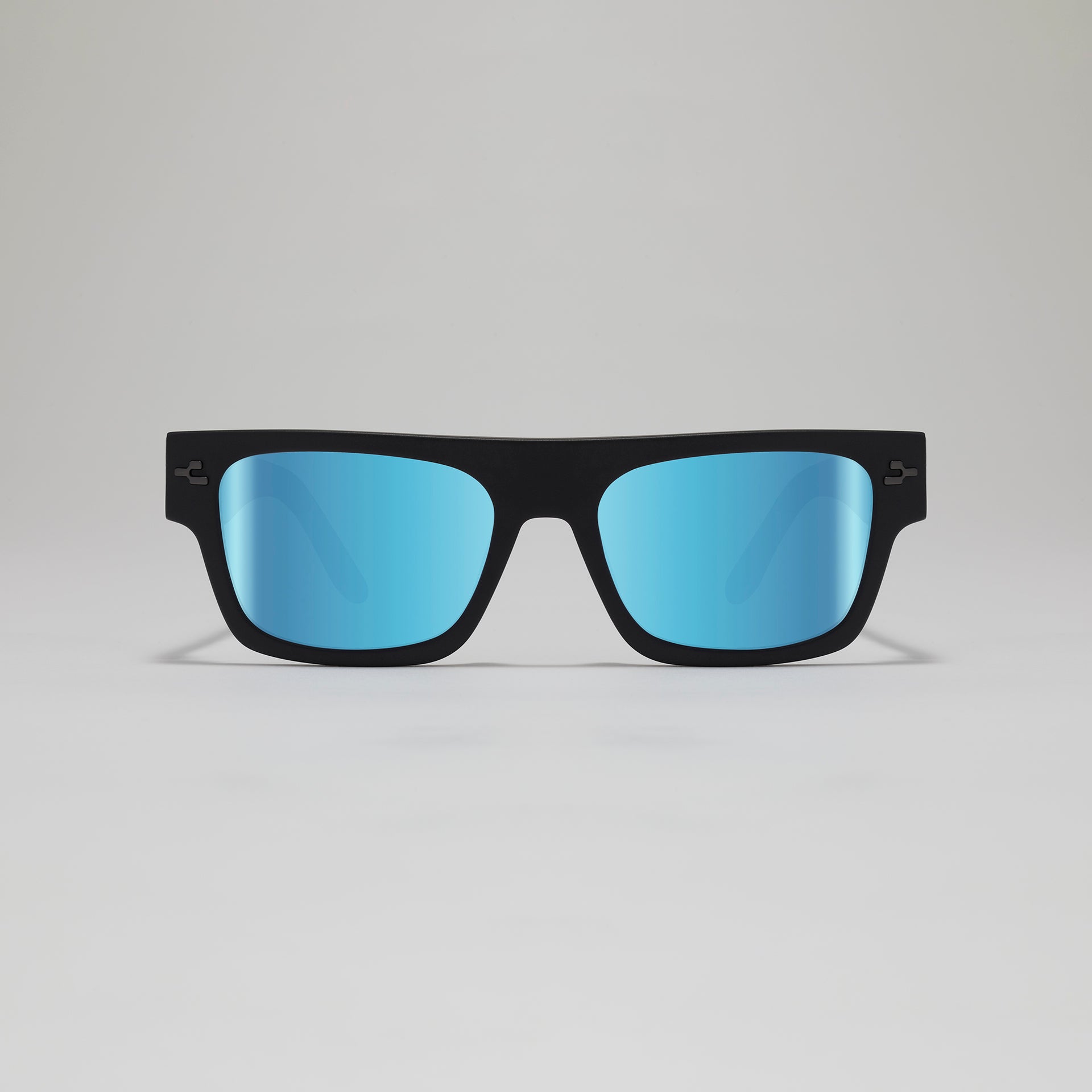 Black sunglasses with blue lenses on a gray background