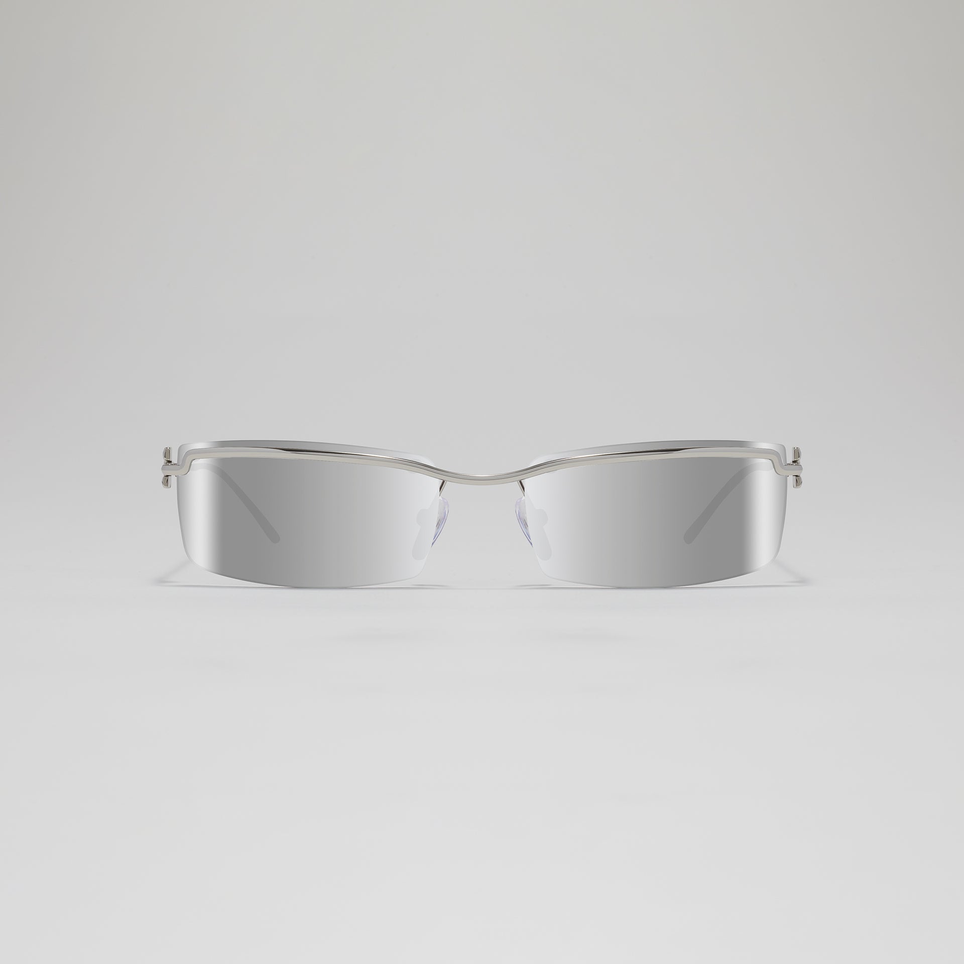 Silver sunglasses on a light gray background