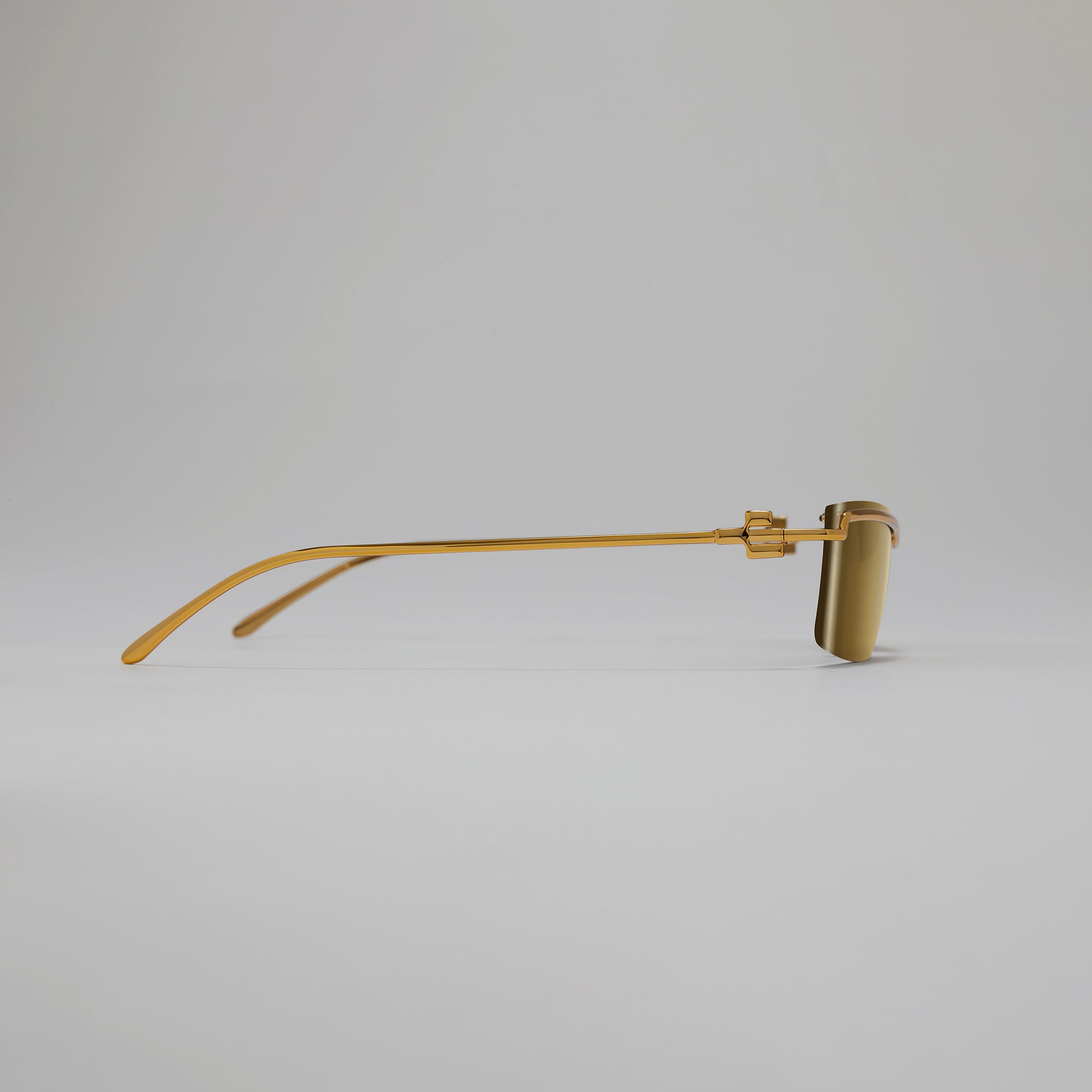 Gold eyeglasses on a light gray background