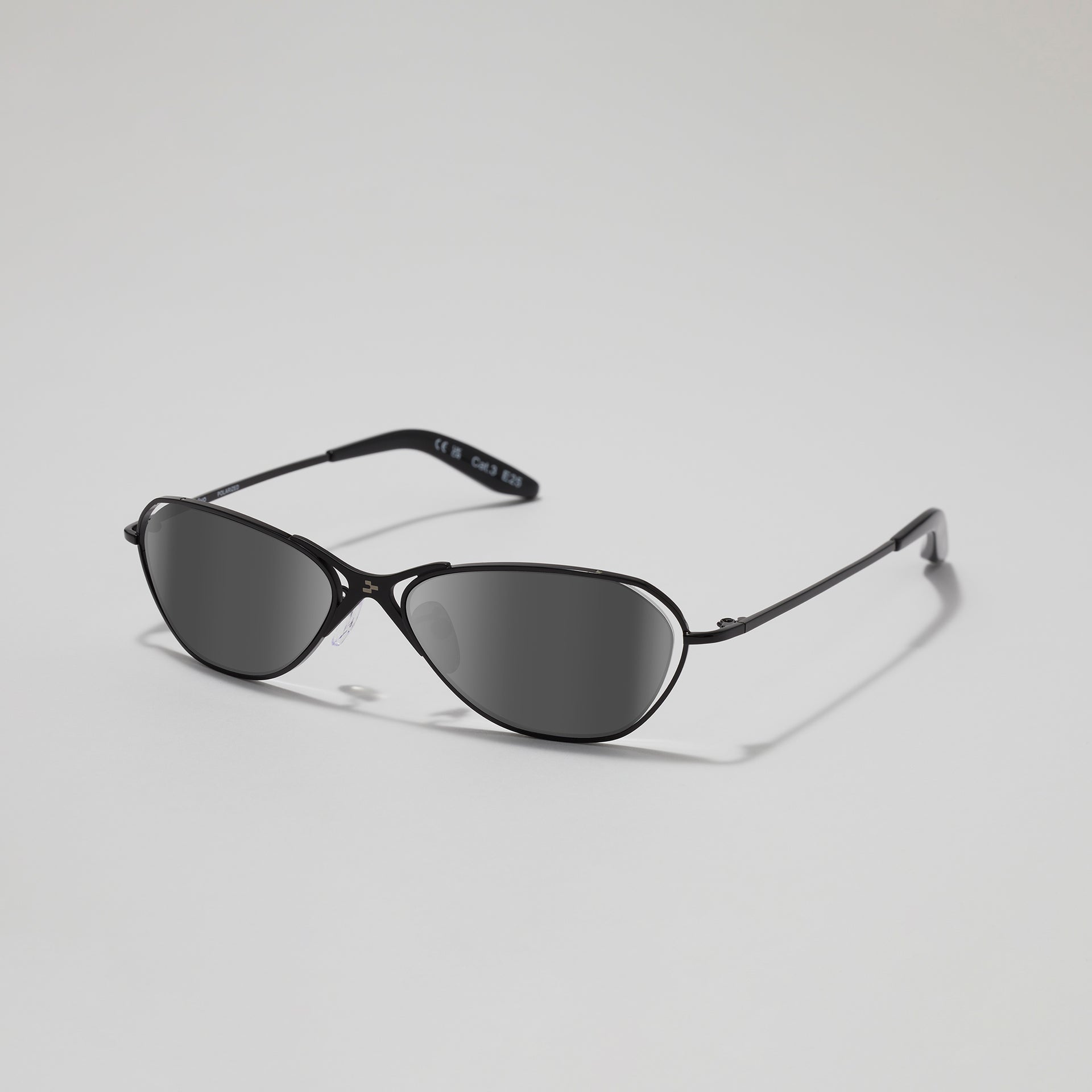Black cat-eye sunglasses on a light gray background