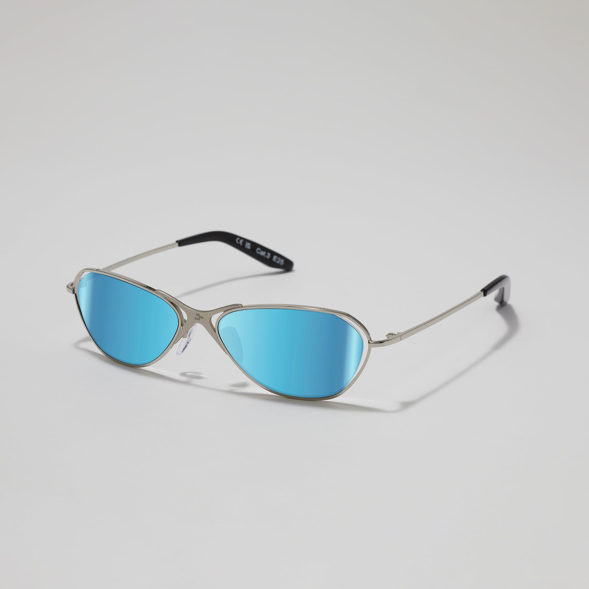 Cat-eye sunglasses with blue lenses on a light gray background