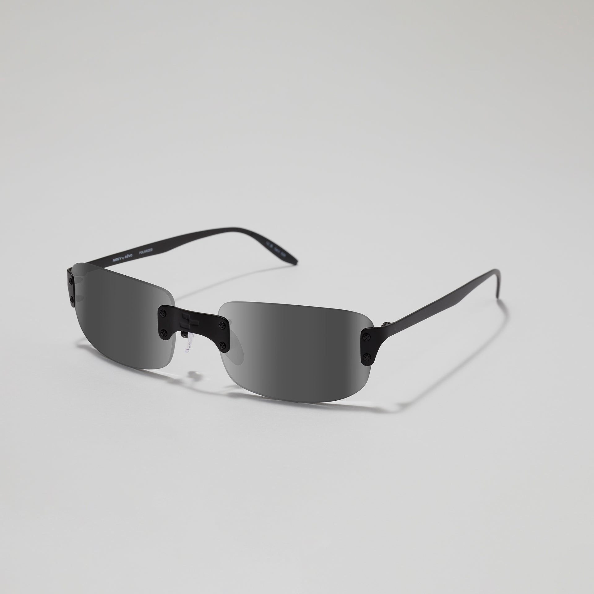 Sunglasses with black frame and dark lenses on a light gray background