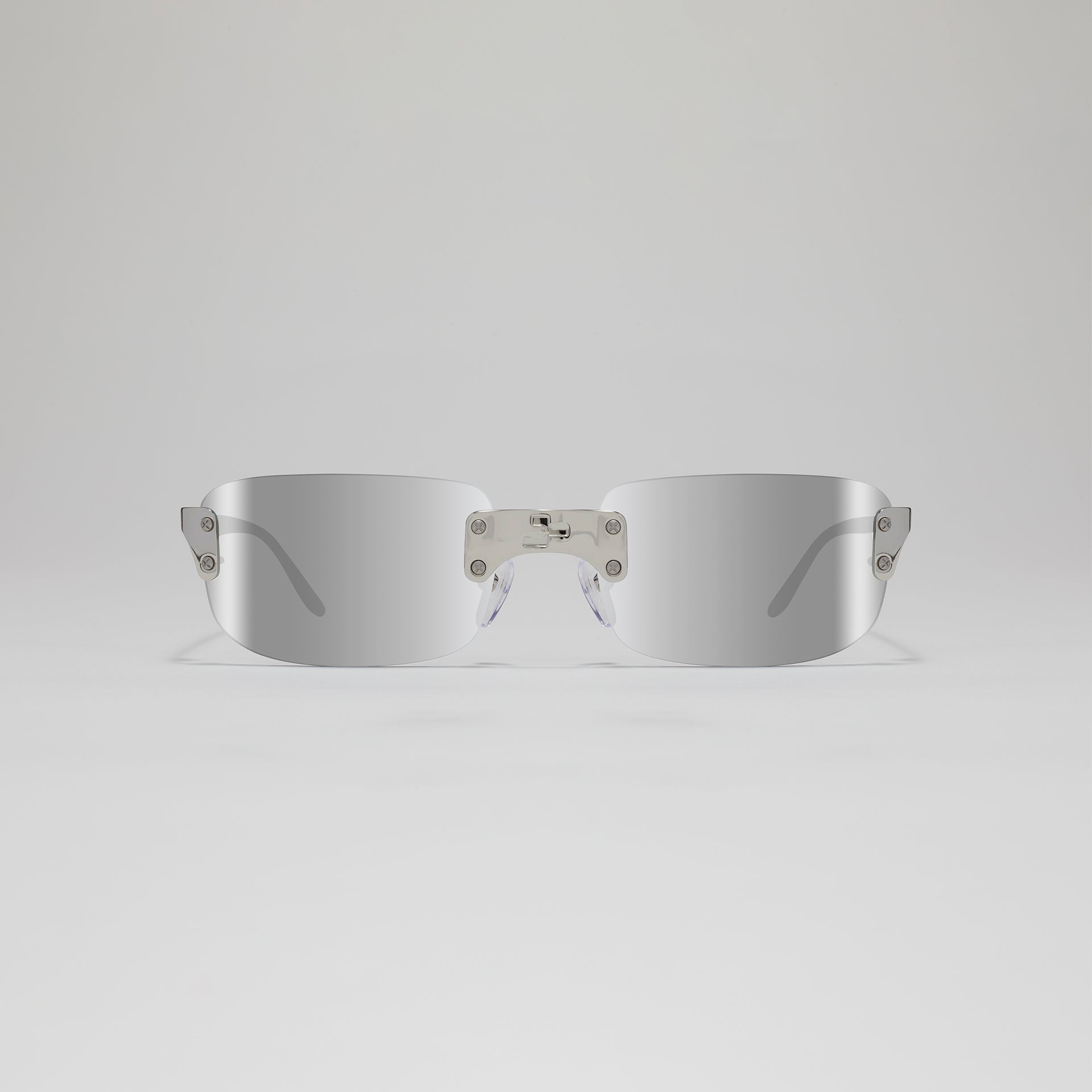 Silver sunglasses on a light gray background