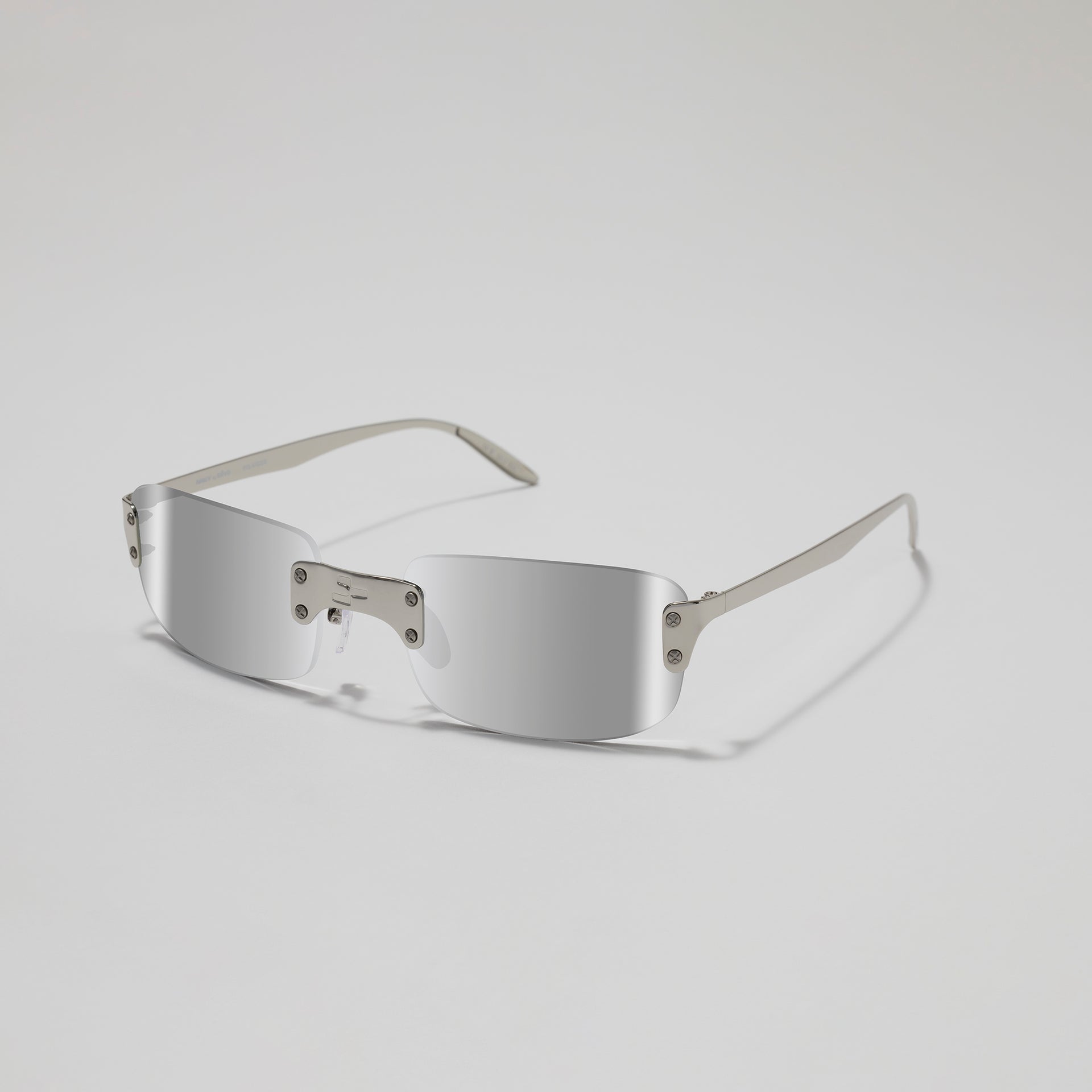 Silver sunglasses on a light gray background