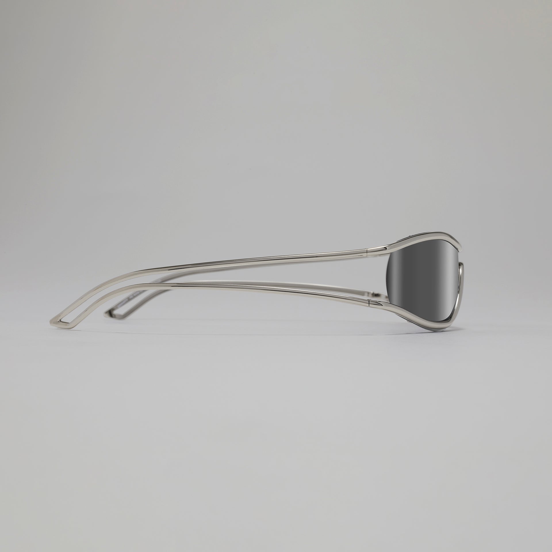 Silver sunglasses on a light gray background