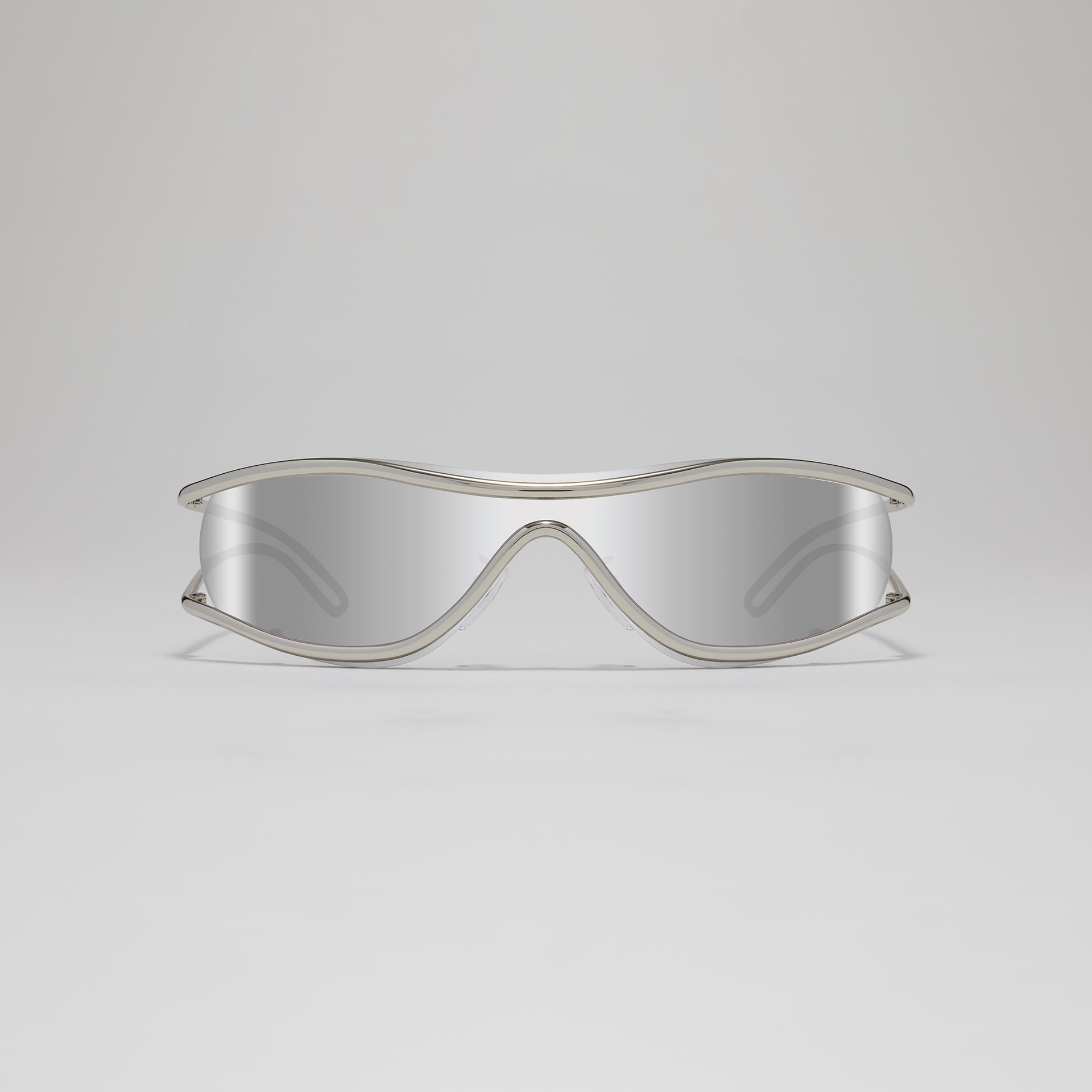 Silver-framed sunglasses on a light gray background