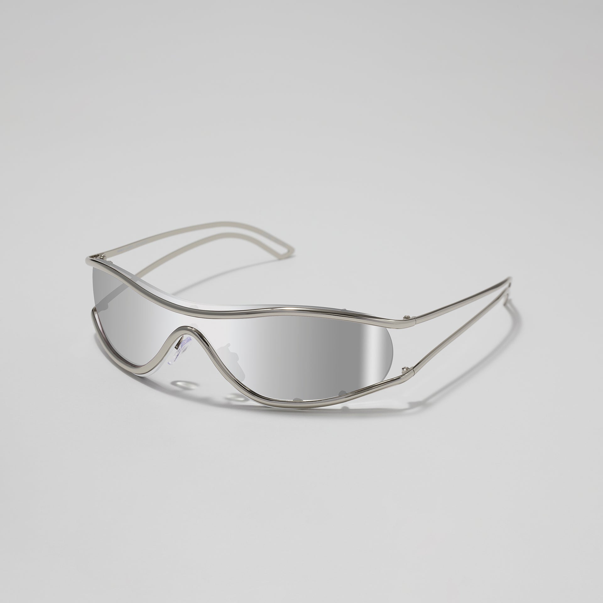 Clear safety goggles on a light gray background