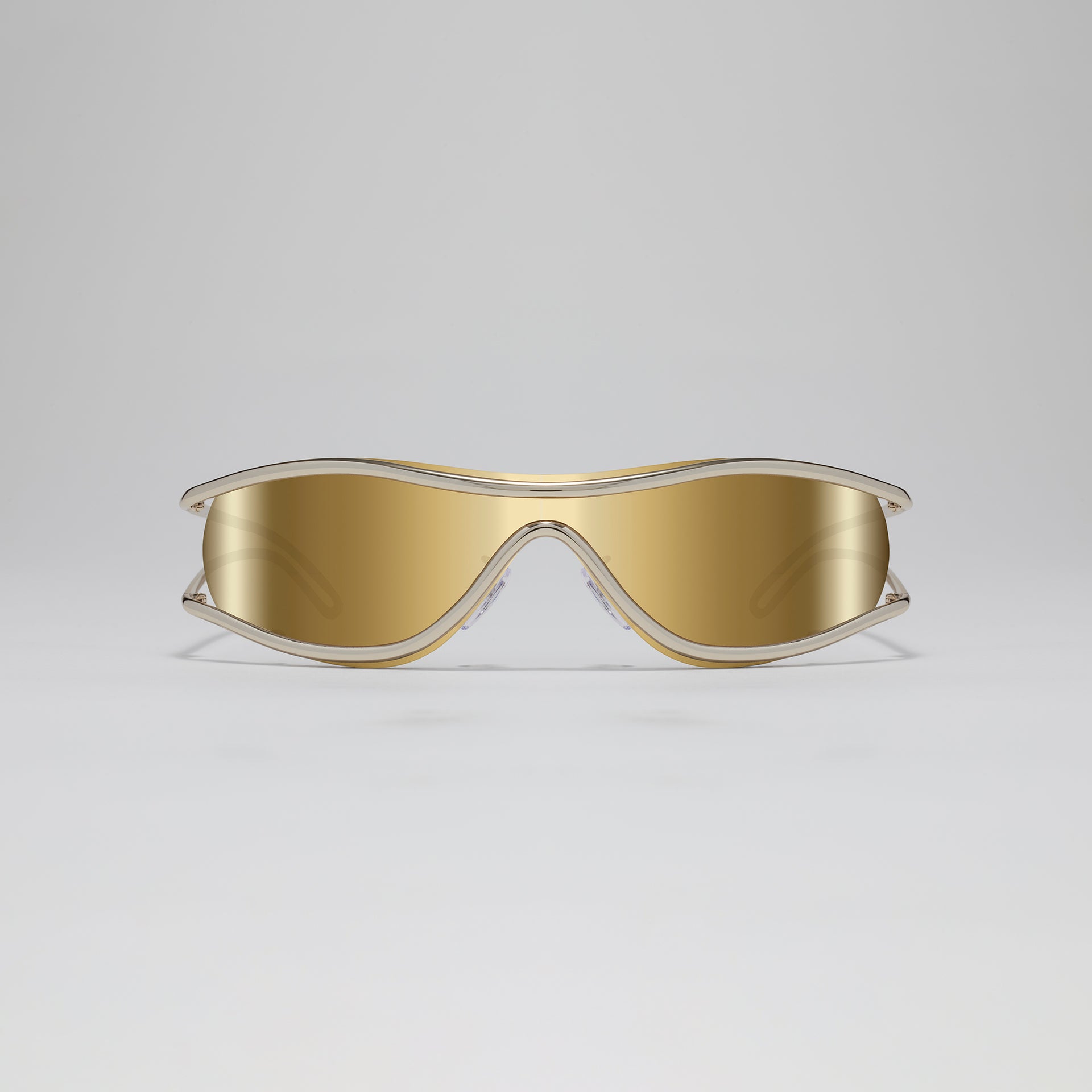 Gold-colored goggles on a light gray background
