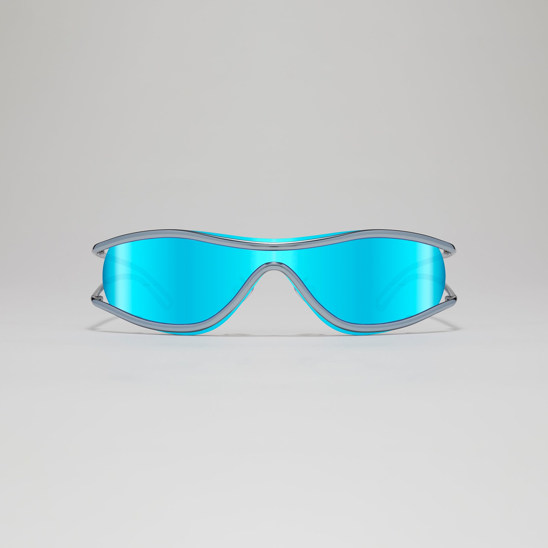 Sunglasses with blue lenses and clear frame on a light gray background