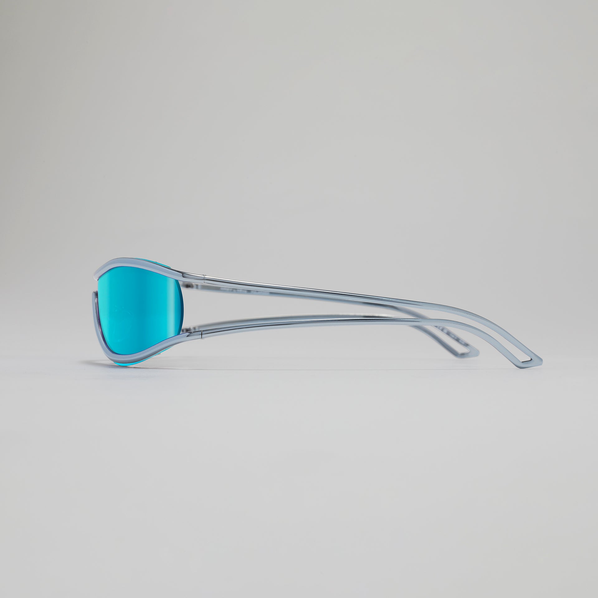Sunglasses with blue lenses and clear frame on a light gray background