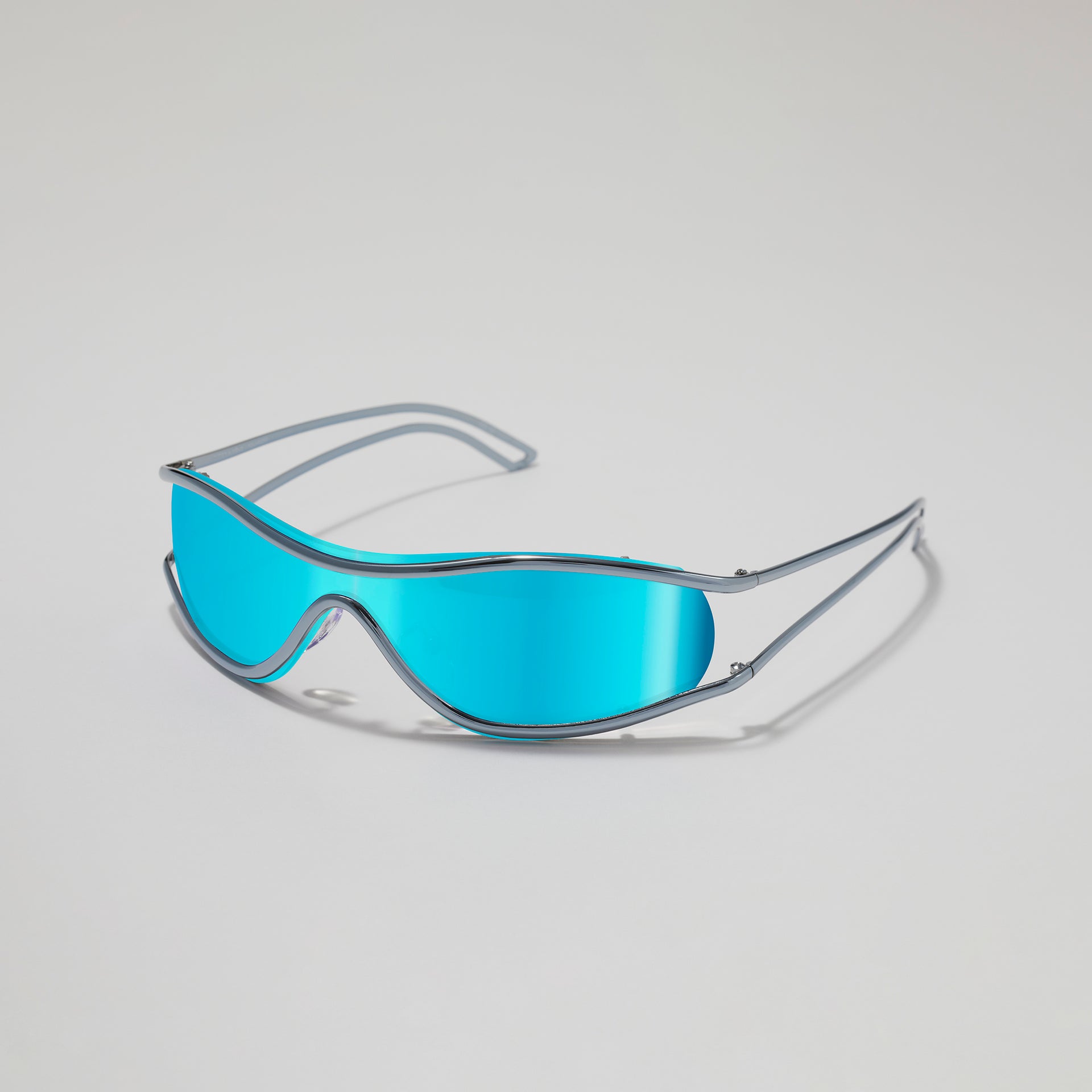 Sunglasses with blue lenses and silver frame on a light gray background