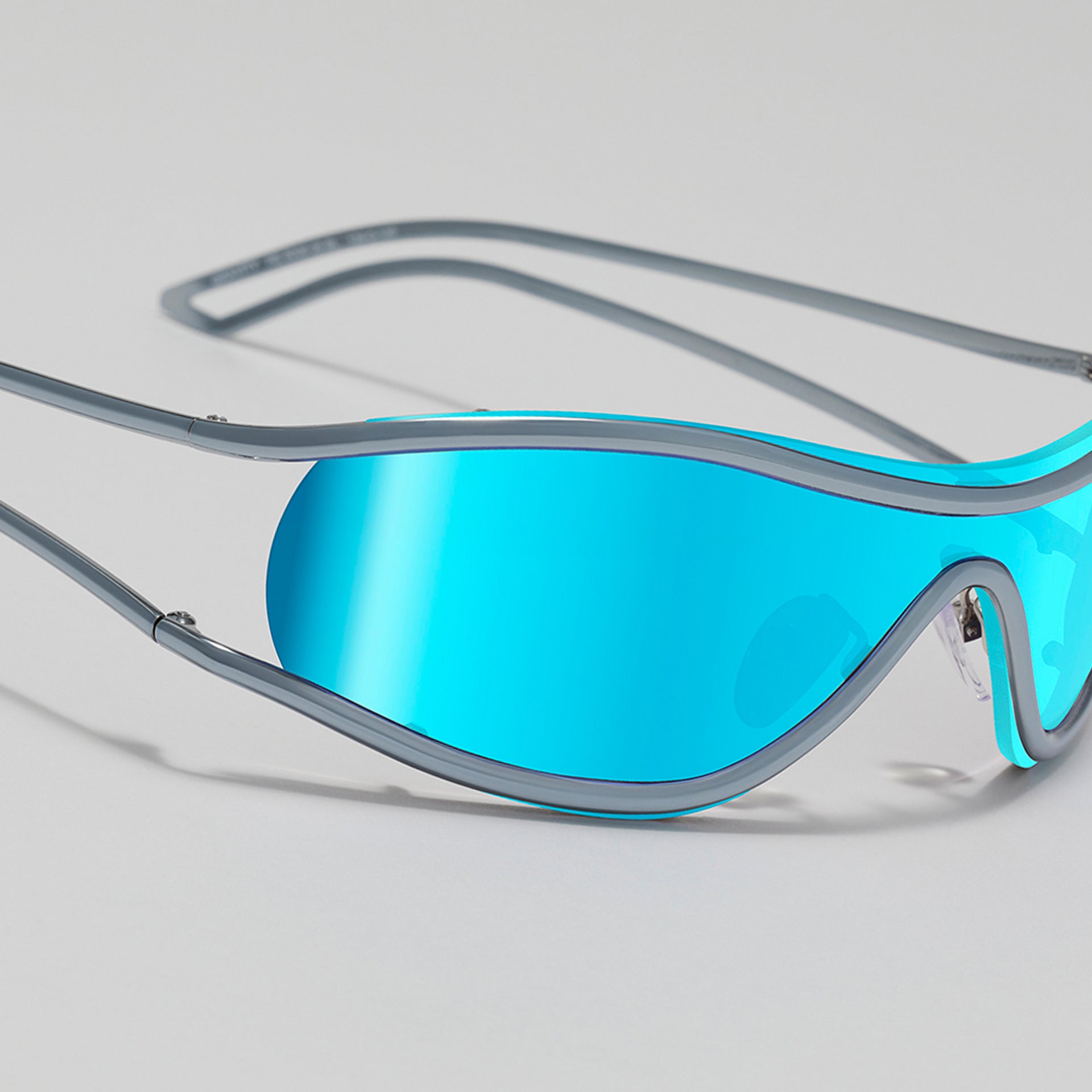 Blue-tinted goggles with gray frame on a light gray background
