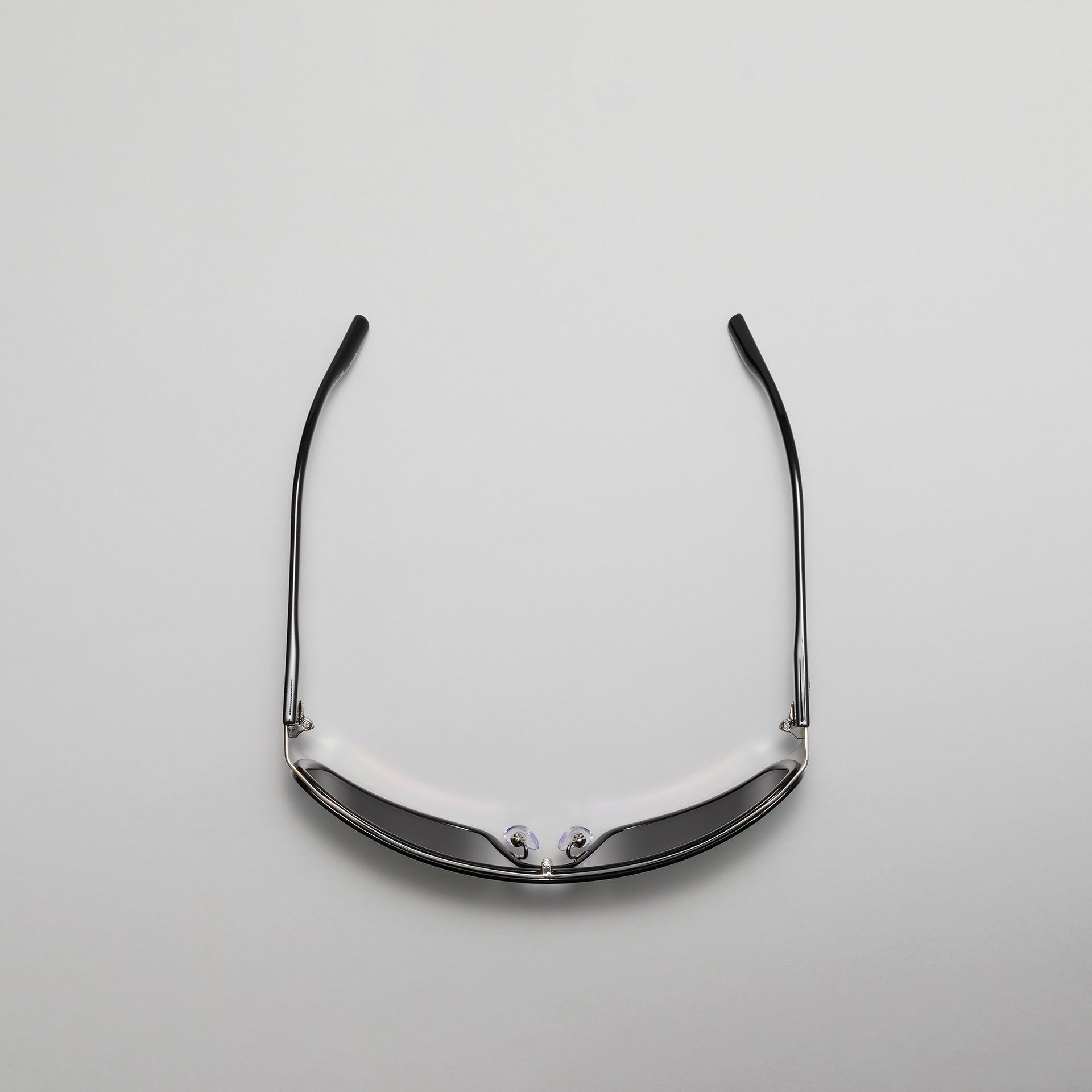 Sunglasses with a reflective surface on a light gray background