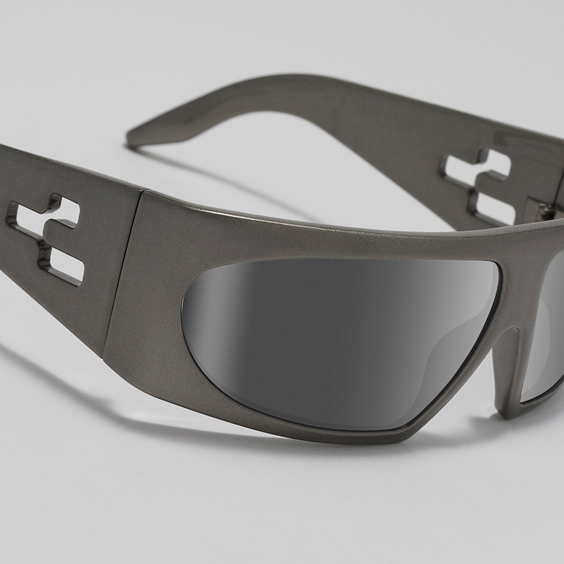 Sunglasses with a metallic frame on a light gray background