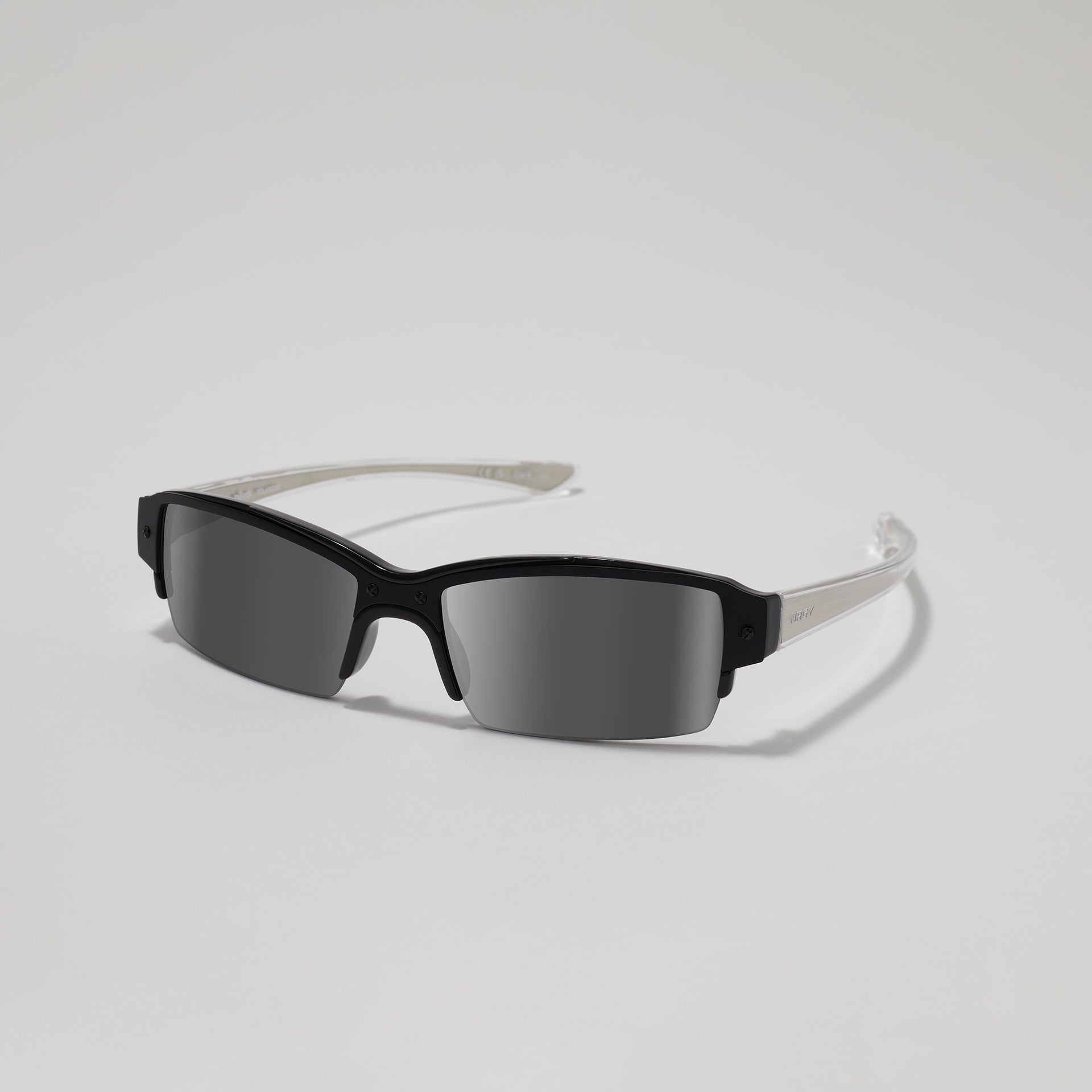 Black sunglasses with a silver frame on a light gray background