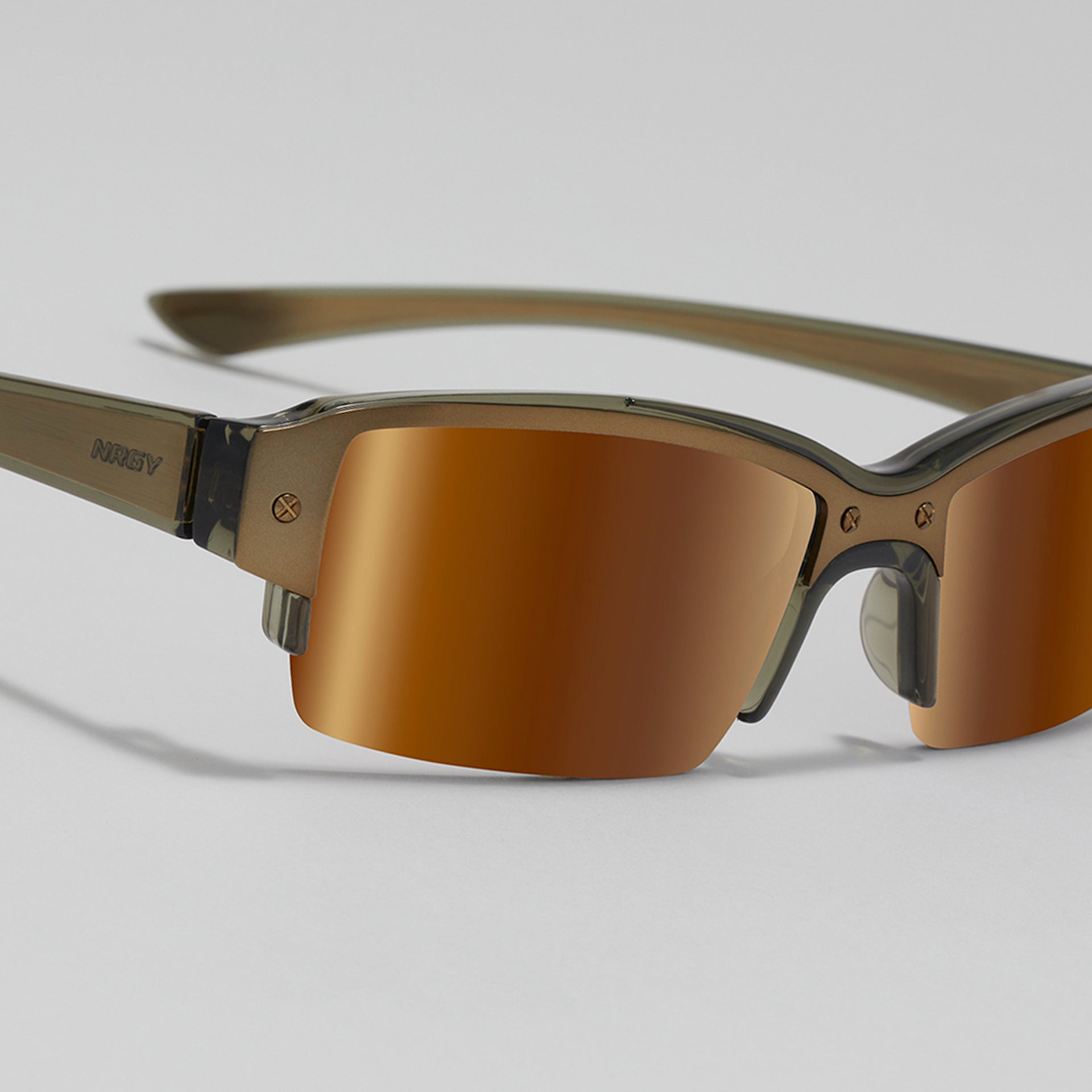 Sunglasses with brown lenses and gold frame on a light gray background