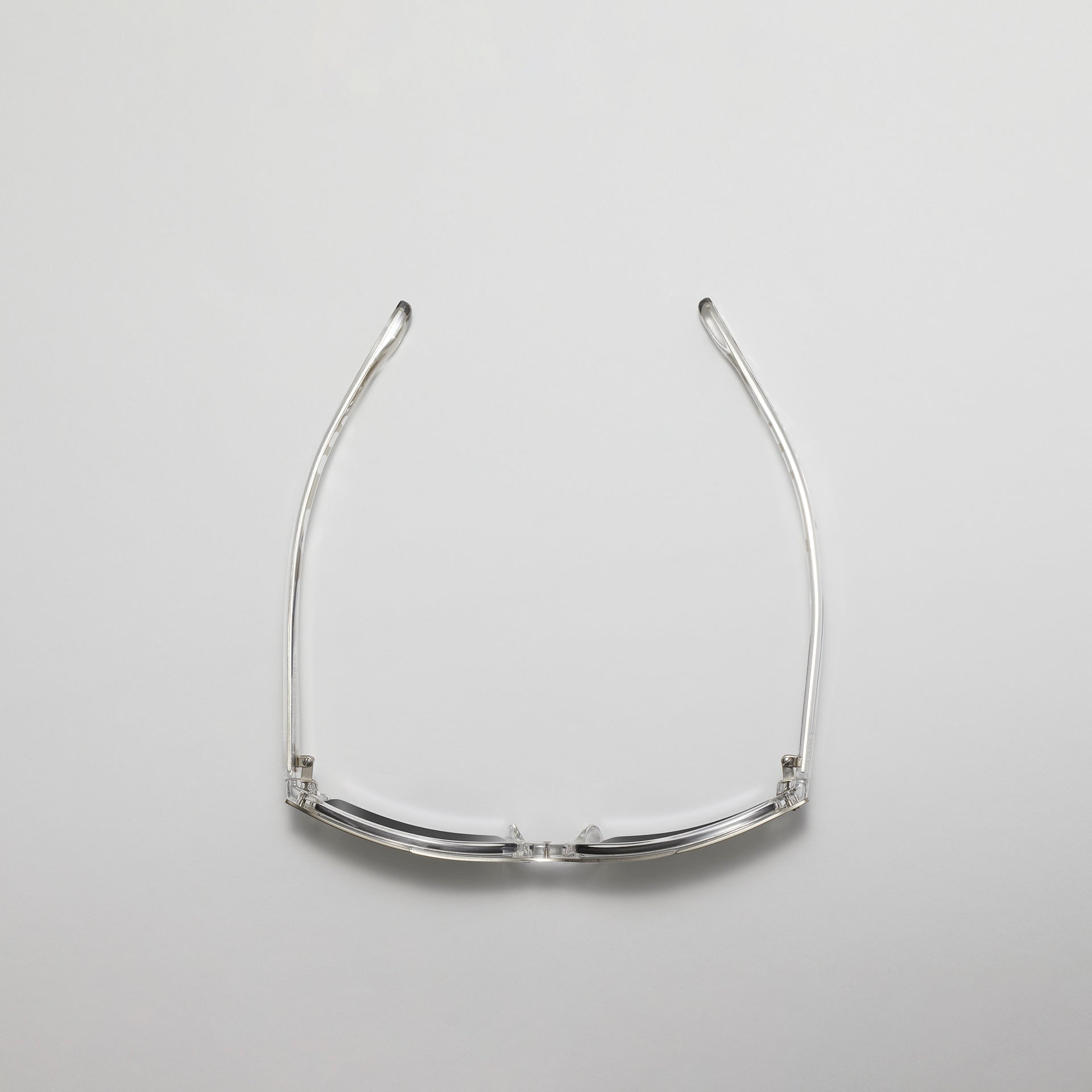 Silver eyeglass frame on a light gray background