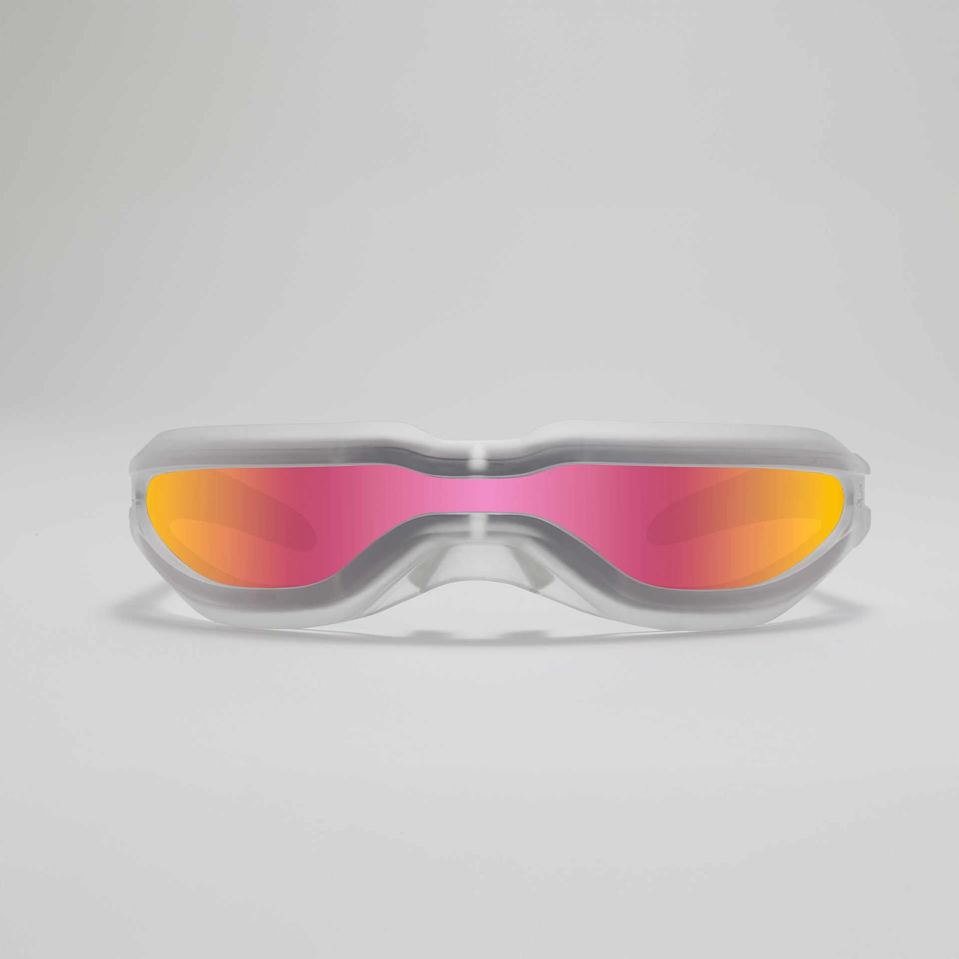Goggles with pink and orange lenses on a light gray background