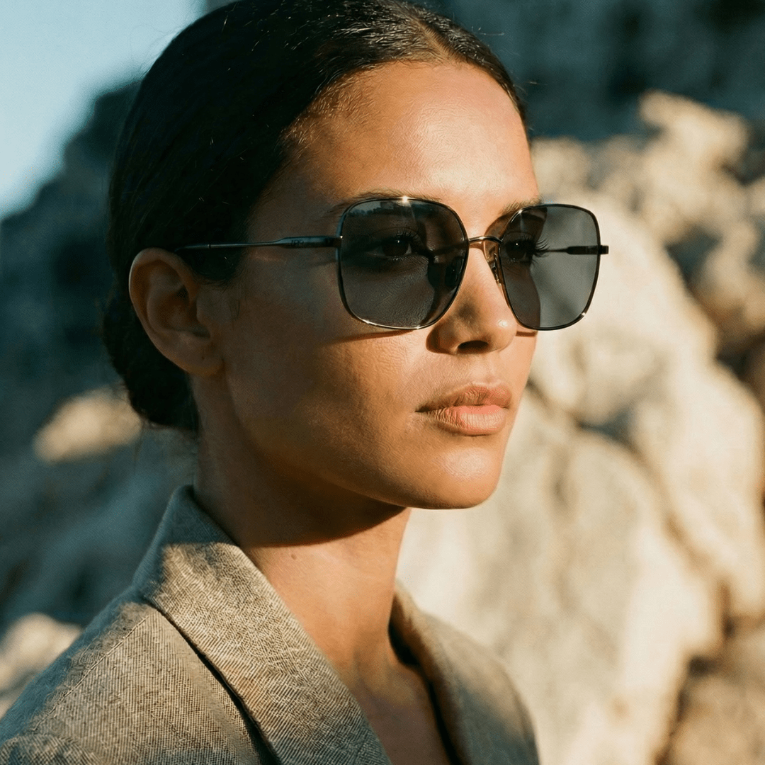 Model wearing Bella oversized metal sunglasses with a slim frame and dark lenses