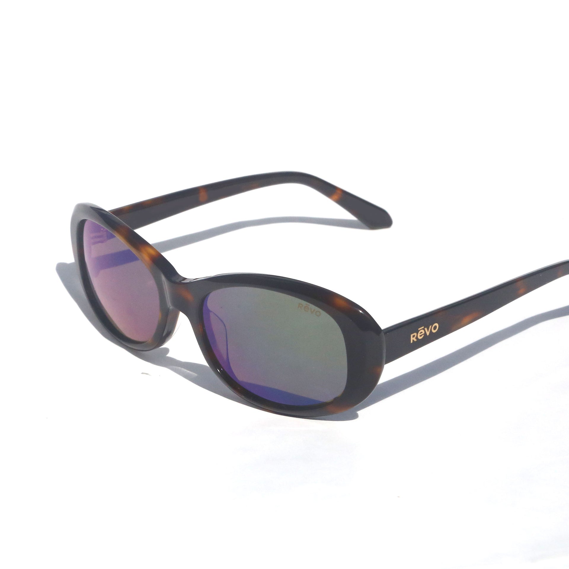 Sunglasses with tortoiseshell frame and purple lenses on a white background