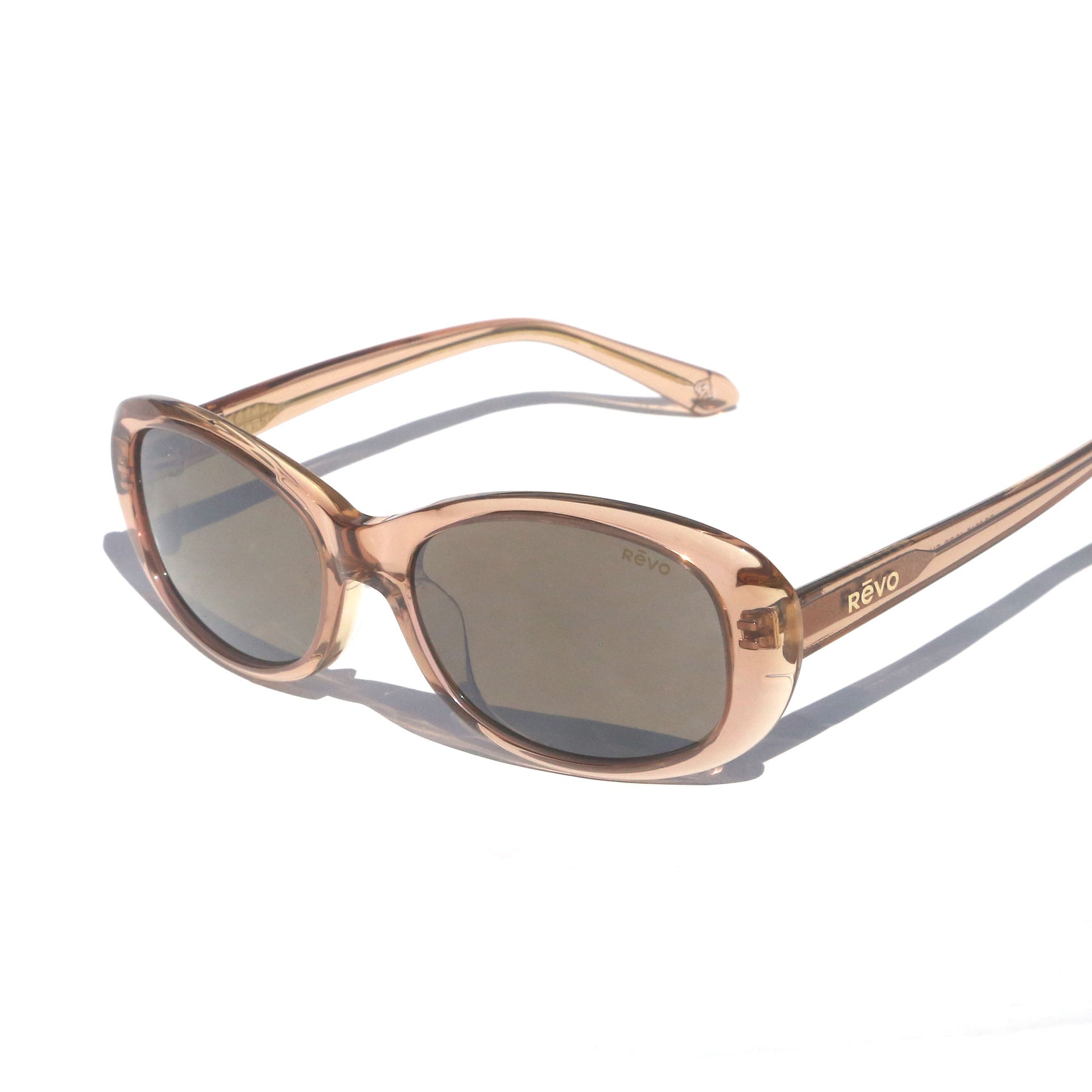 Sunglasses with rose gold frame and dark lenses on a white background