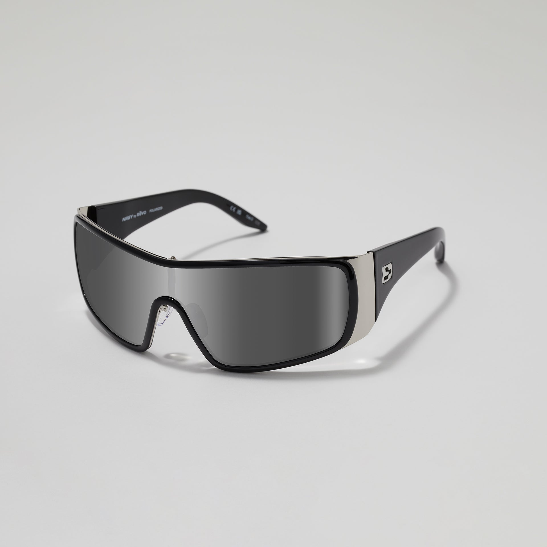 Black sunglasses with a reflective lens on a light gray background