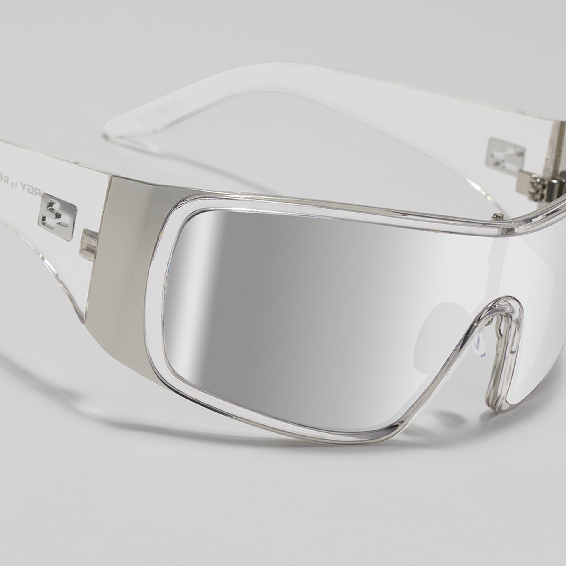 Clear safety goggles with silver frame on a white background