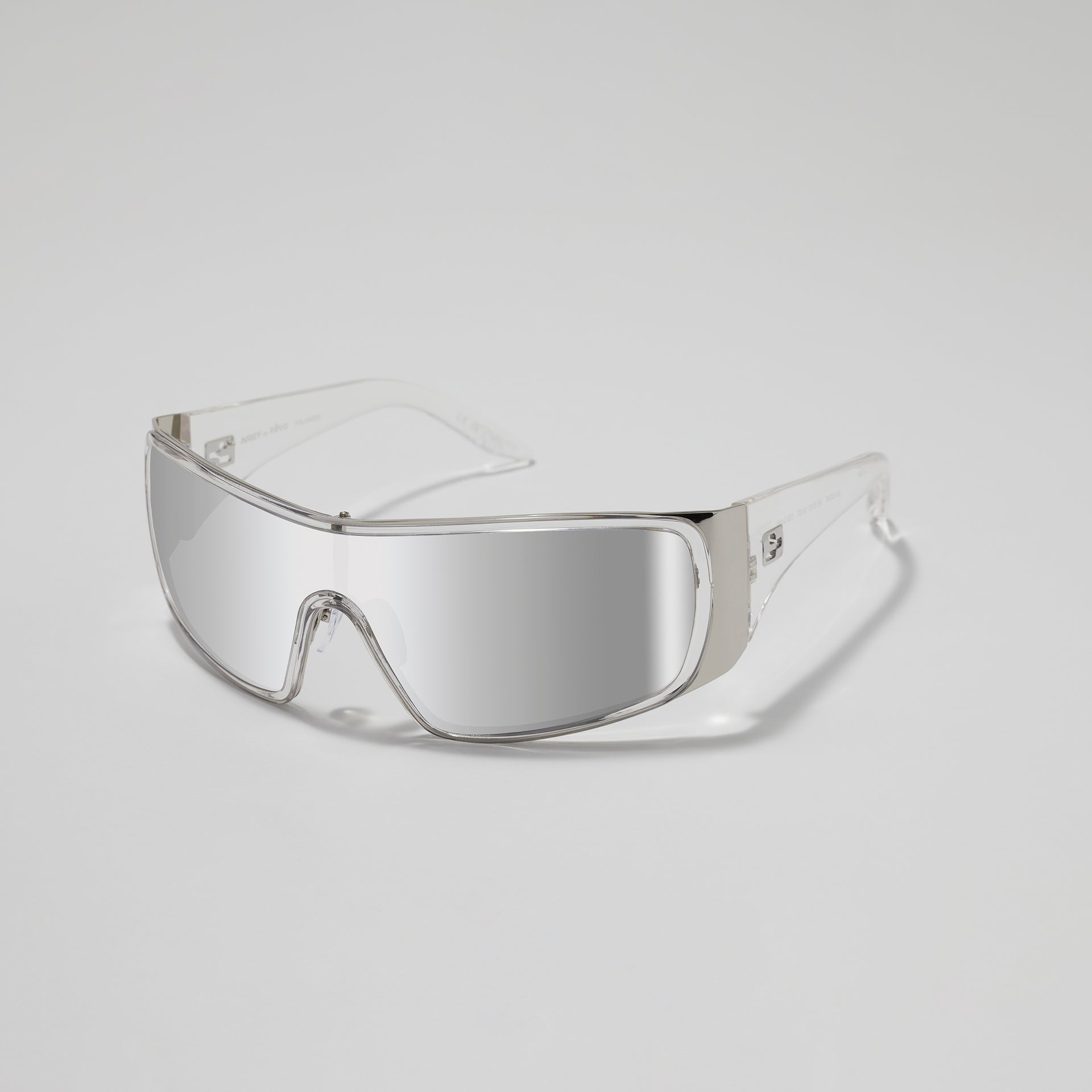 Clear safety goggles on a light gray background