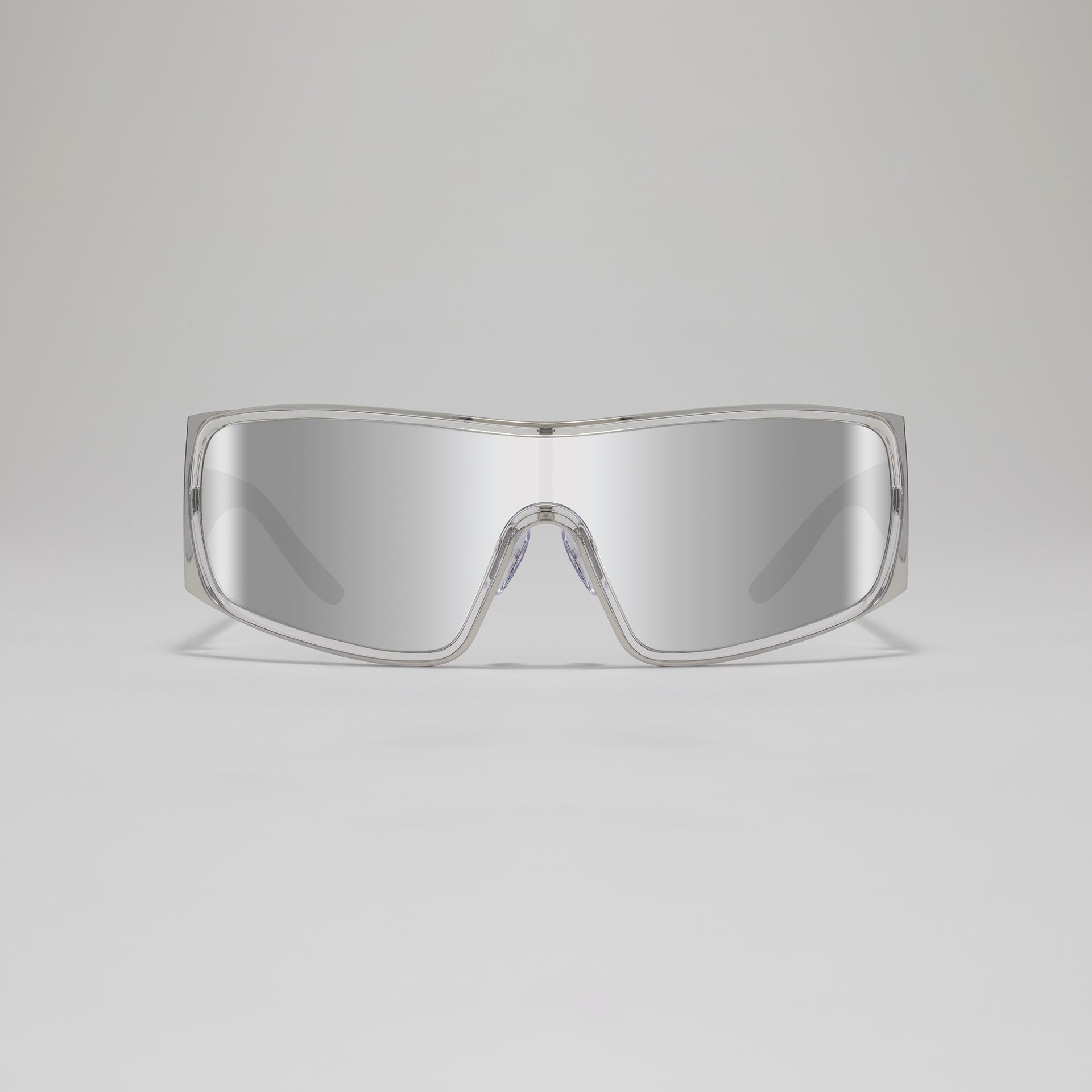 Clear protective goggles on a gray background