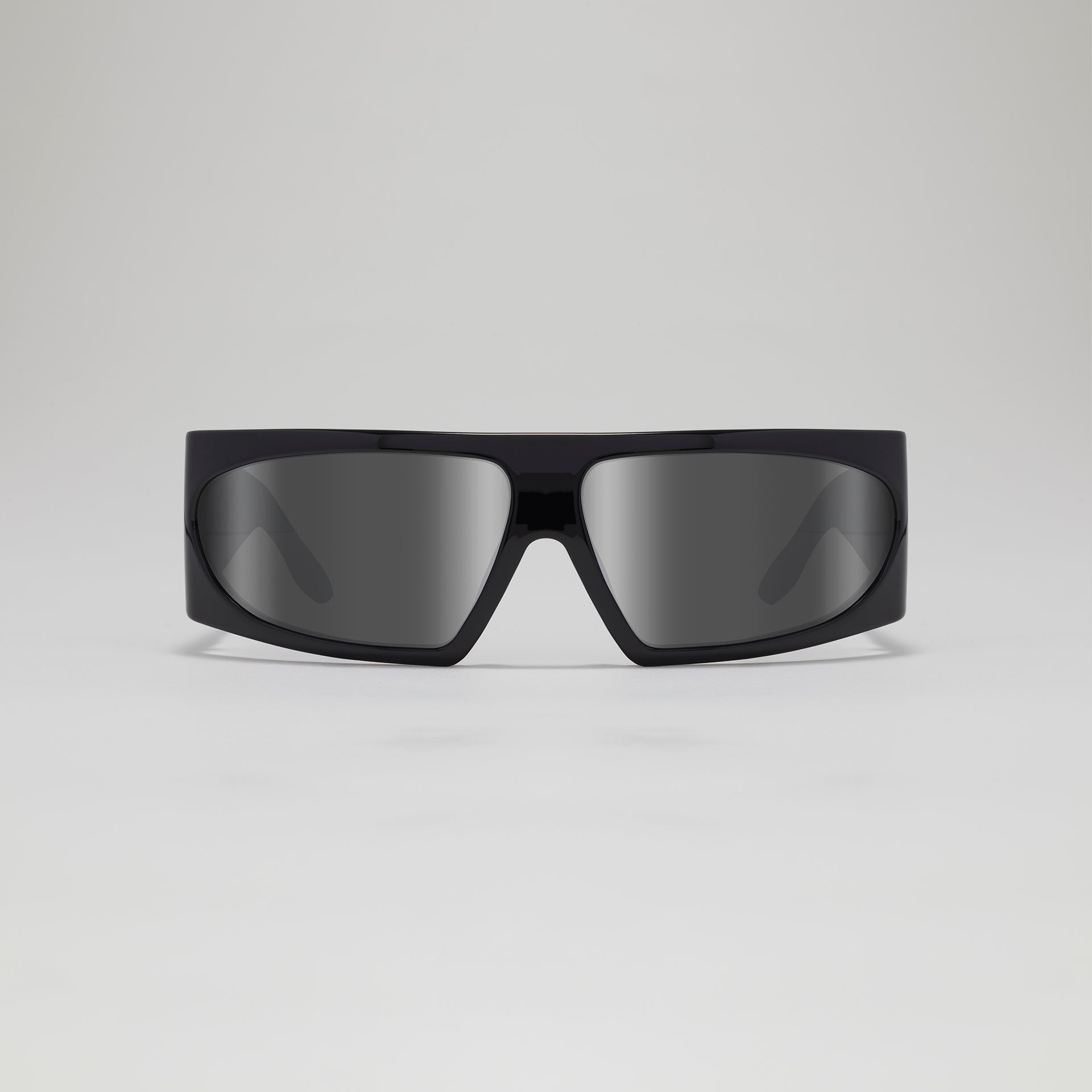 Black sunglasses with dark lenses on a light gray background