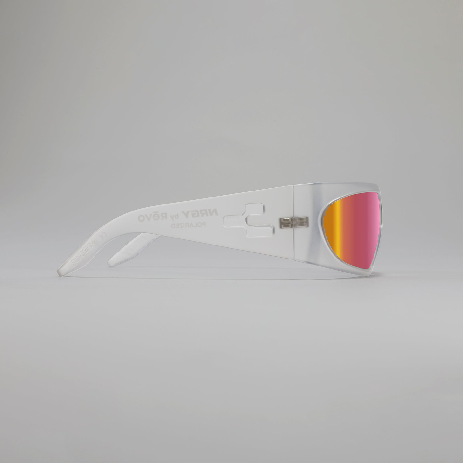 White sunglasses with pink-tinted lenses on a gray background
