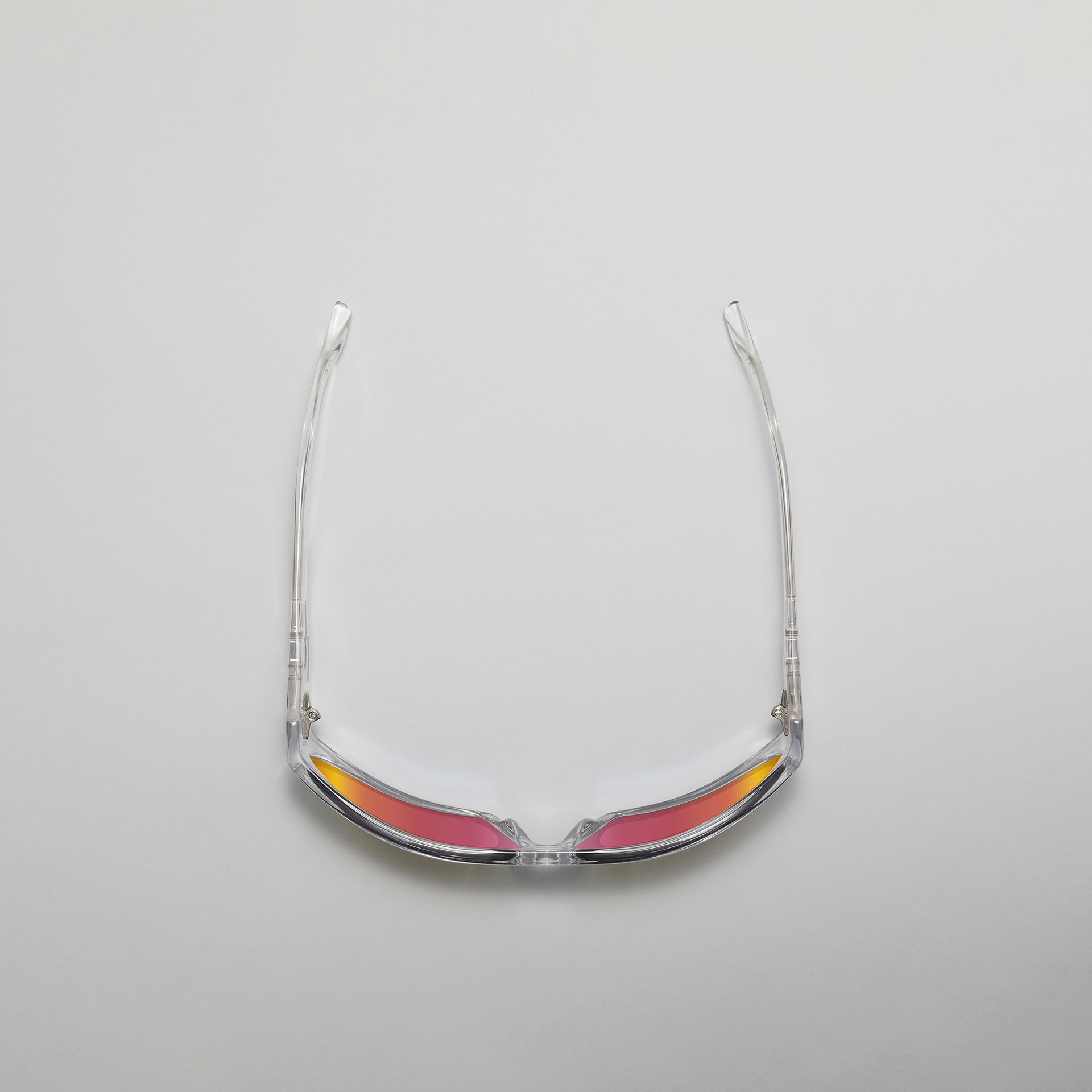 Clear eyeglass frame on a gray background