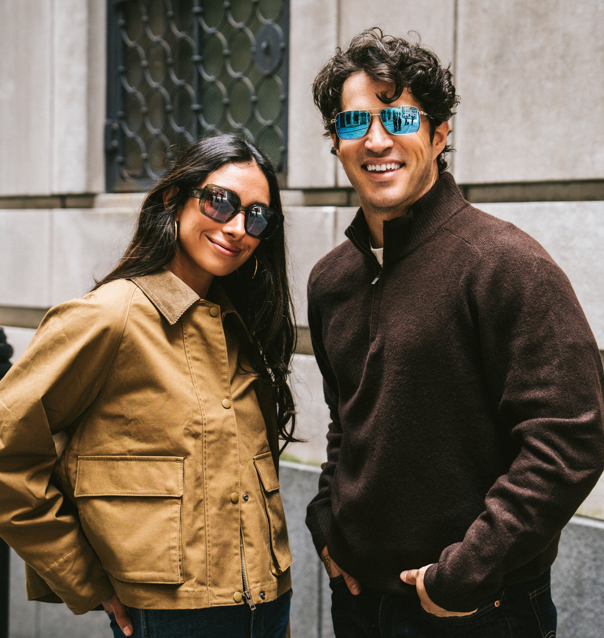 Two people wearing Revo sunglasses on a city street