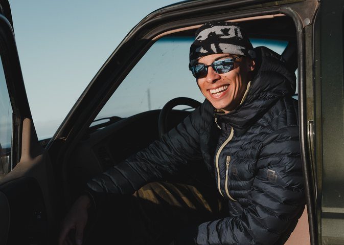 Driver smiling in a truck wearing Revo sunglasses